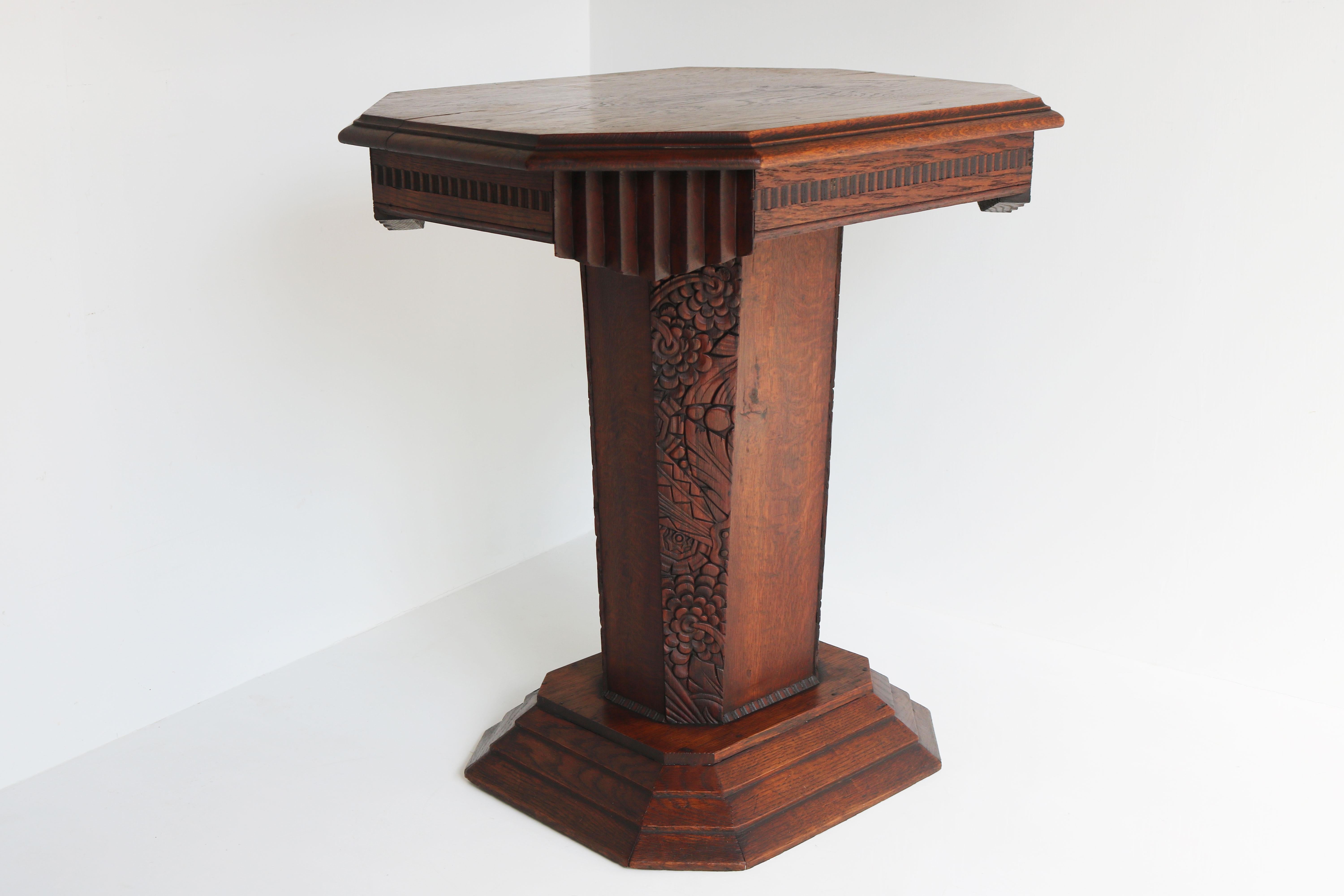 Gorgeous high quality Art Deco side table made out of solid oak 1920 France. 
Octagon shaped with 4 hand carved panels decorated with Art Deco geometric shapes. 
Really nice details and craftsmanship. Its quality & unique shape make it an amazing