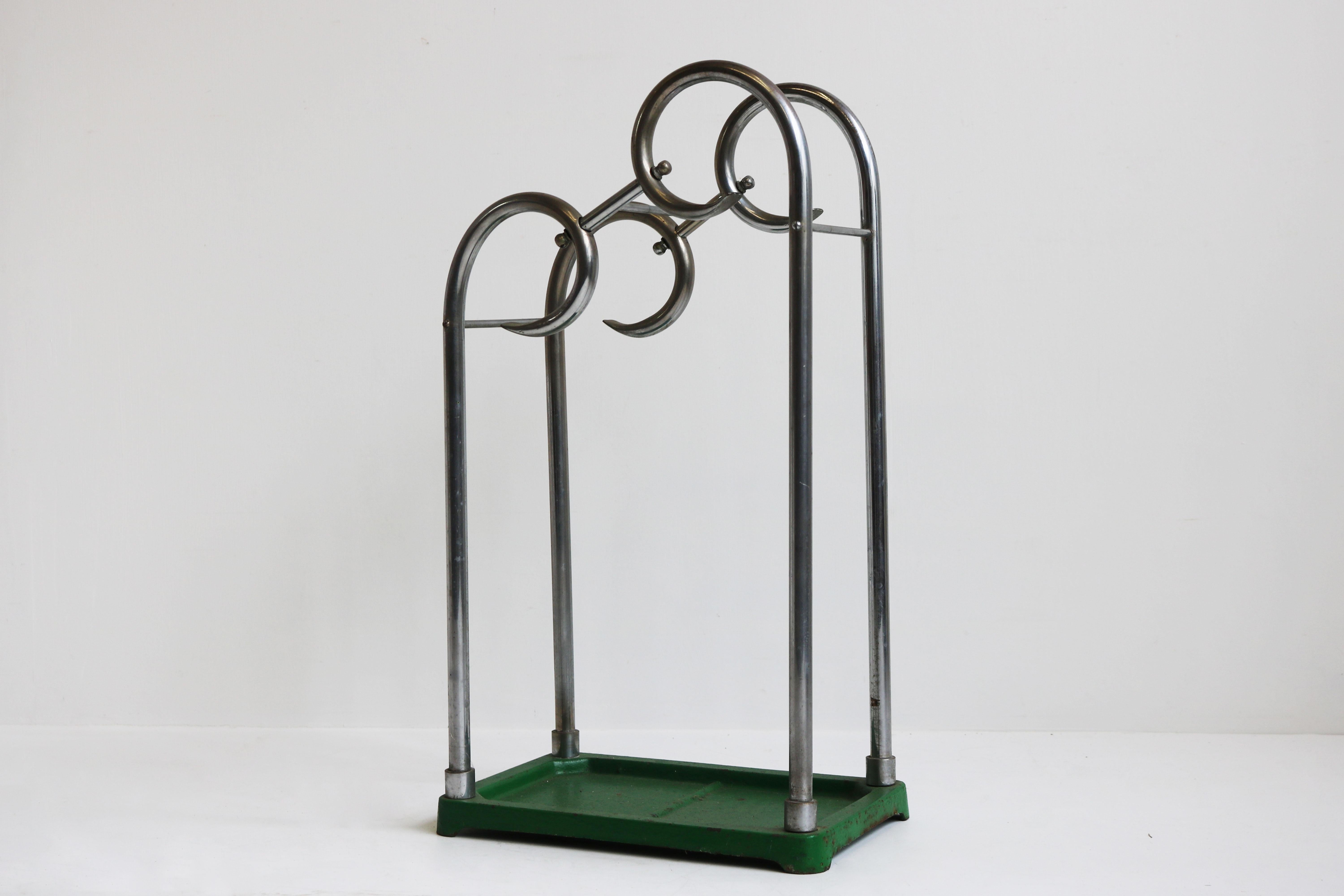 Lovely fully original French Art Deco umbrella stand from the 1930s. 
Stylishly shaped tubular chrome with cast iron green base. 
Fully original with great patina , chrome shines nicely. 
very practical for small apartment hallways.