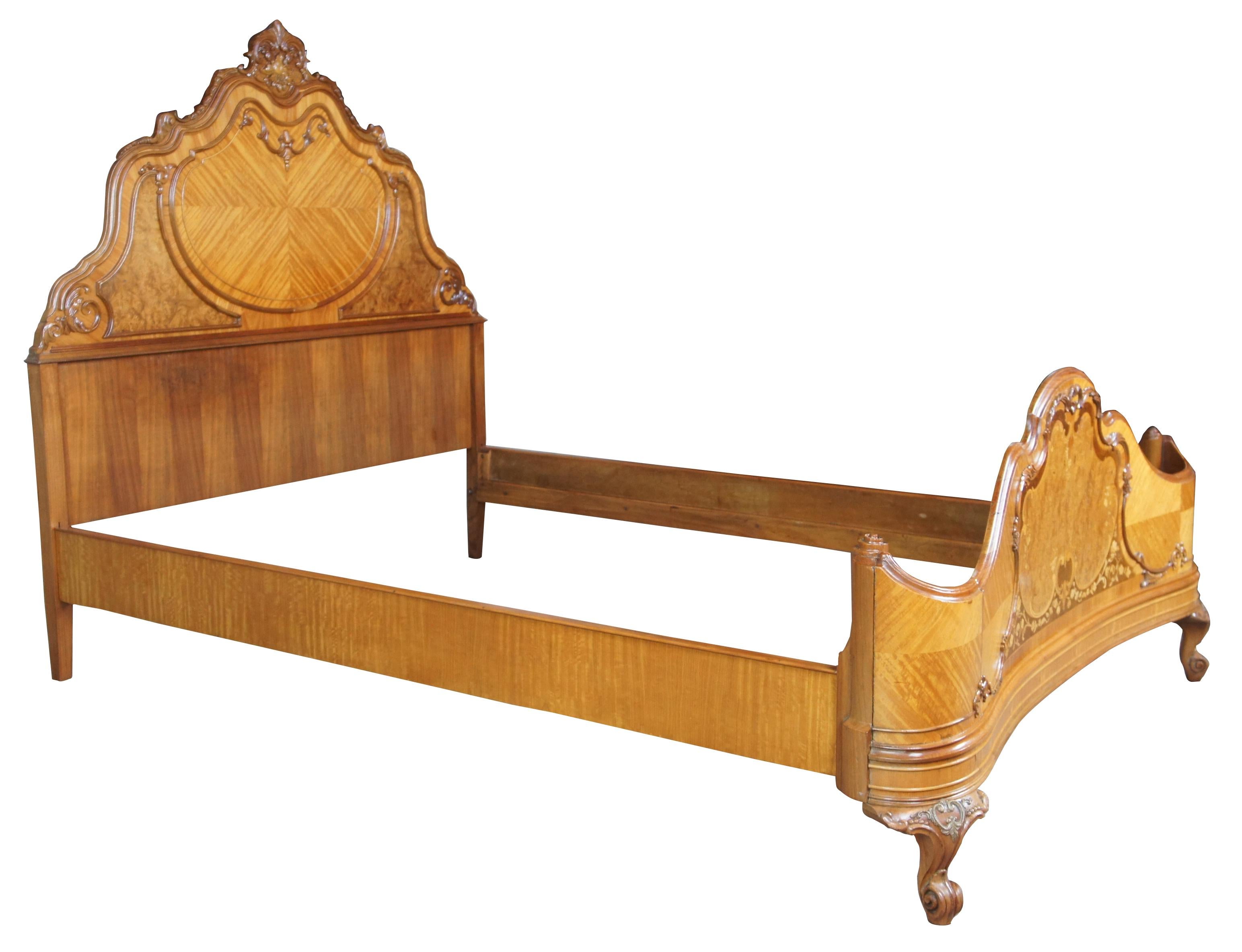 French wrap around bed, circa 1920s. Features a curved shape with ornate detail, scalloped top, matchbook veneering and burled accents. Made from walnut.
 
Footboard Height - 28.5