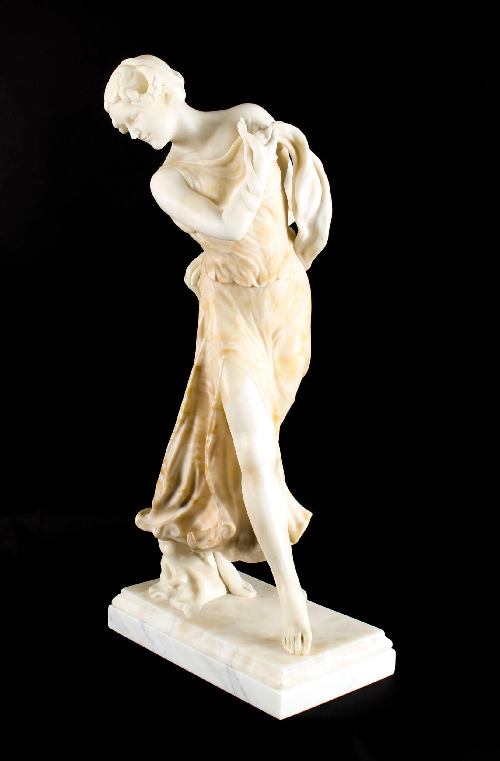 This is a splendid antique French Art Nouveau snow-white and red alabaster sculpture of a graceful dancing lady in classical dress on a striking Verde Antico marble pedestal, circa 1890 in date. 

This finely carved sculpture depicts a beautiful