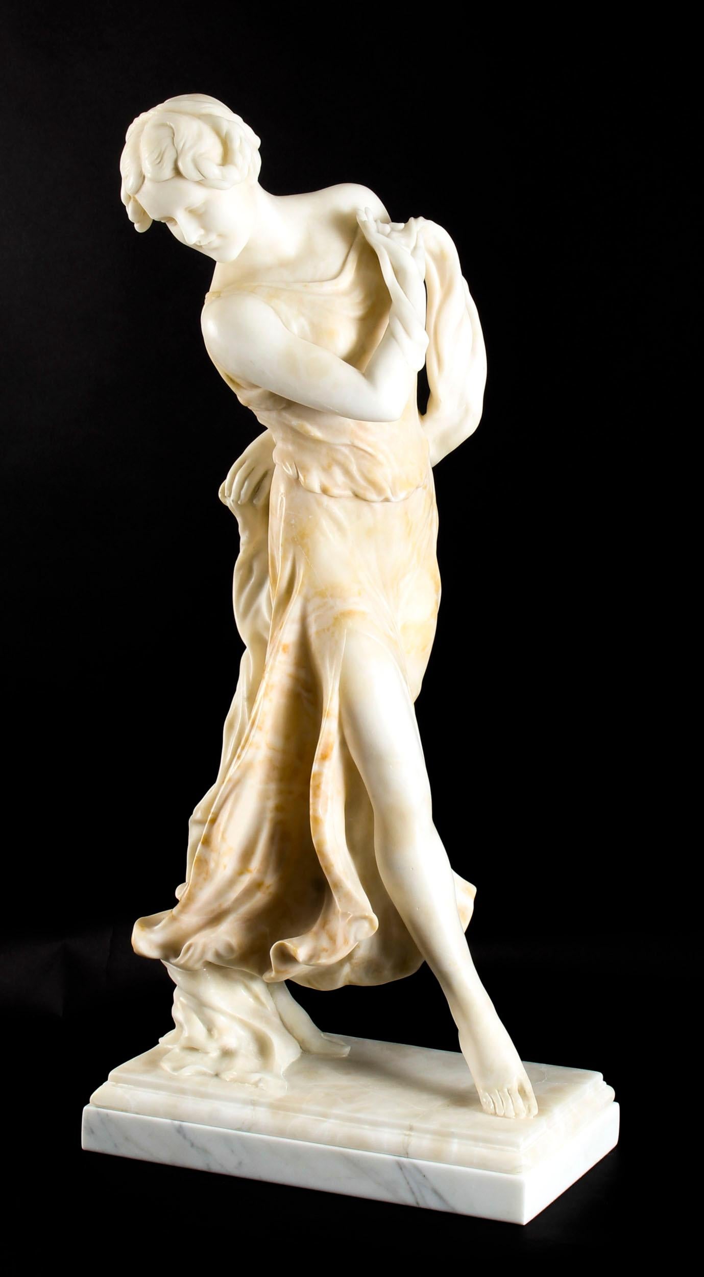 This is a splendid antique French Art Nouveau snow-white and red alabaster sculpture of a graceful dancing lady in classical dress, circa 1890 in date. 

This finely carved sculpture depicts a beautiful young lady graciously dancing in bare feet