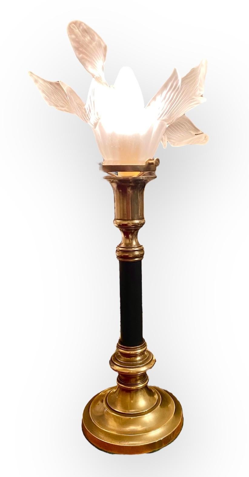 An unusual antique French Art Nouveau style brass candlestick table lamp with a period wispy, floral frosted glass shade. A simple yet elegant lamp that will surely make a statement in your home. Simple yet elegant design can make a show in a