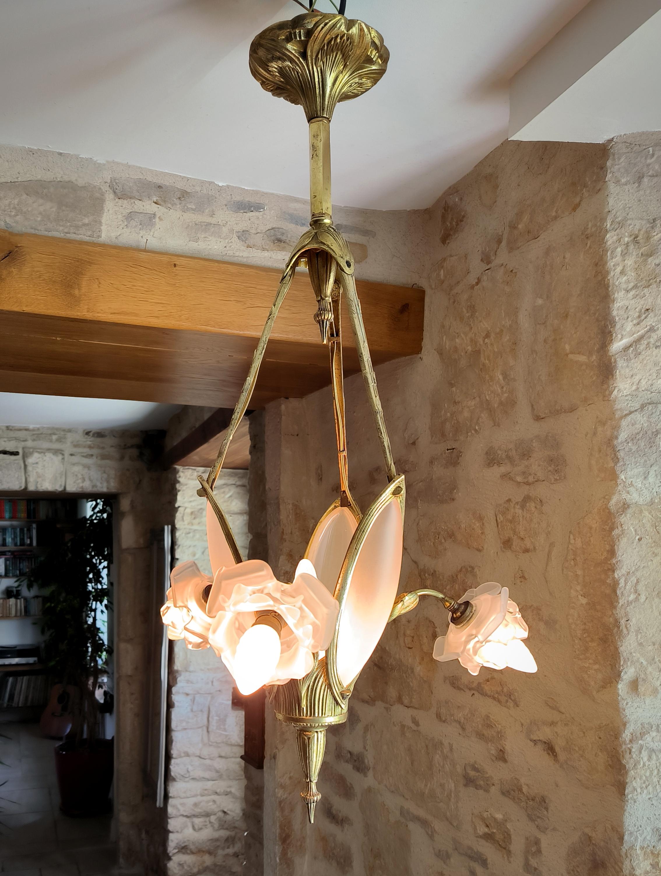 Sourced in the department of Manche, Normandy, France, this magnificent, quintessentially French, Art Nouveau, antique, solid bronze chandelier has a wonderful ethereal feel to it, with its gorgeously sinuous floral bronze body work and stunning