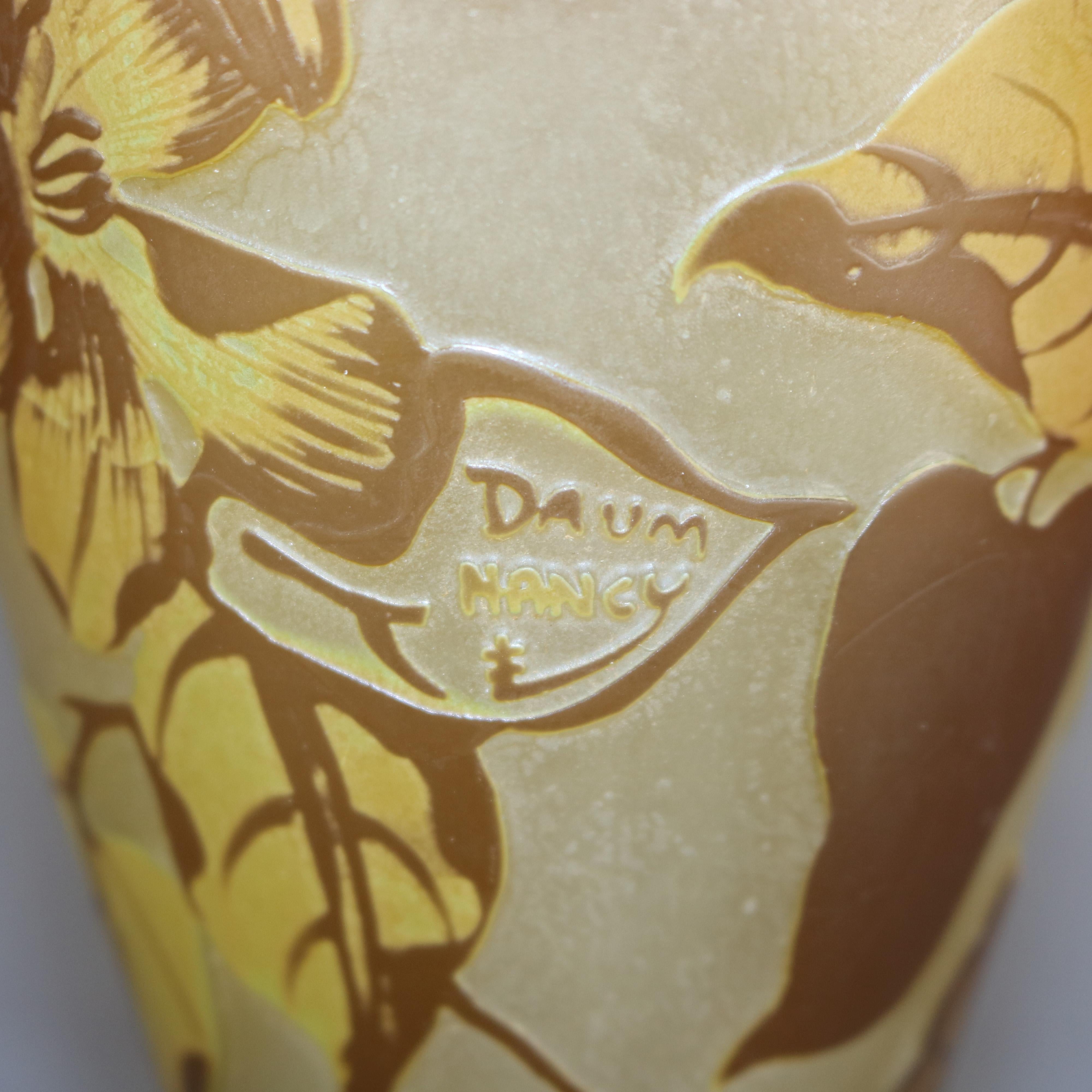 An antique French Art Nouveau art glass vase by Daum Nancy offers hourglass form having cameo cutback allover floral Dogwood design, signed on leaf as photographed, c1900.

Measures: 16.75