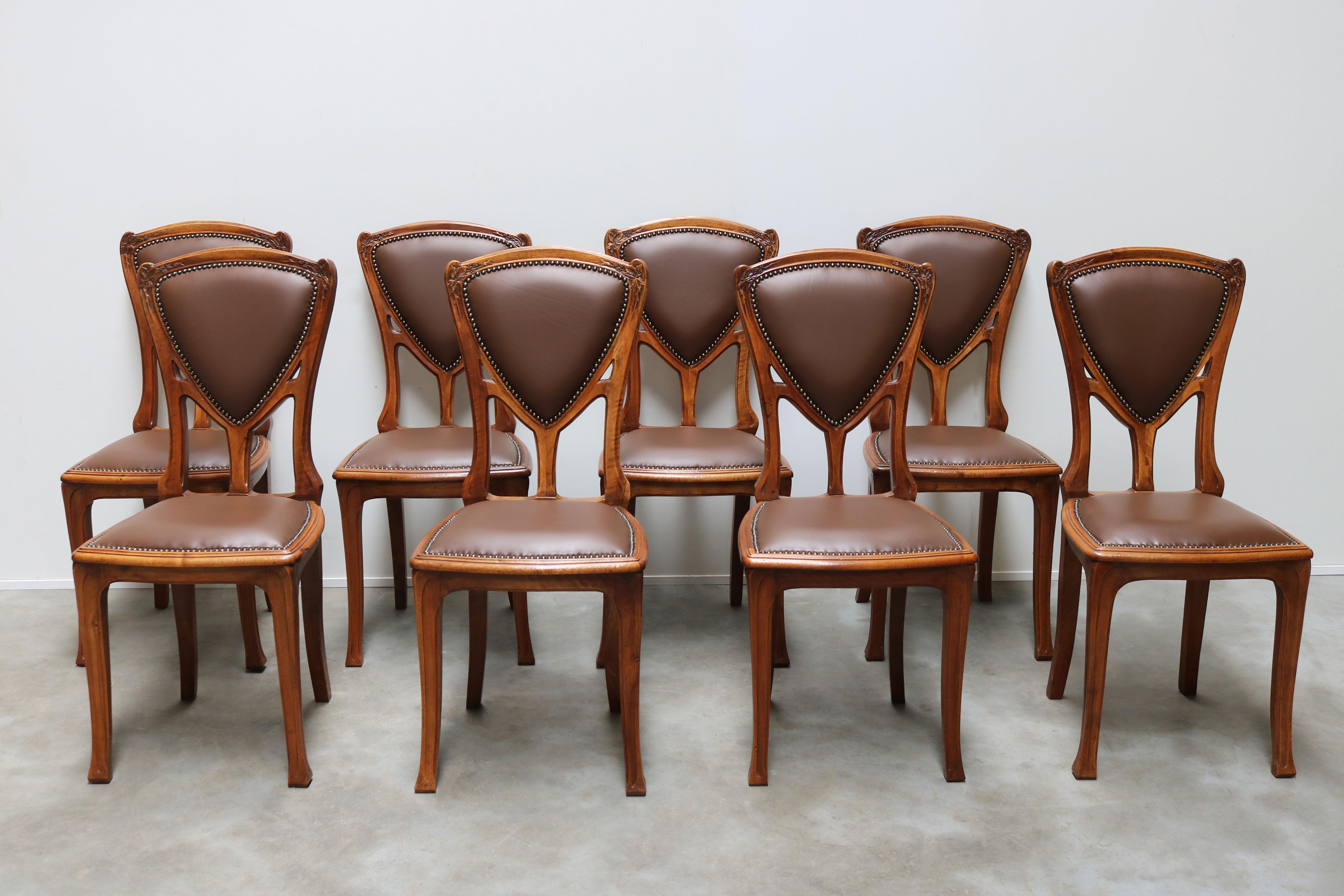 Exquisite & most rare! This French Art Nouveau dining set consisting of 8 chairs and matching table by Eugène Vallin in solid walnut. The chairs where designed for the famous art nouveau building /project ''La Maison Bergeret'' 1903-1904. 
The