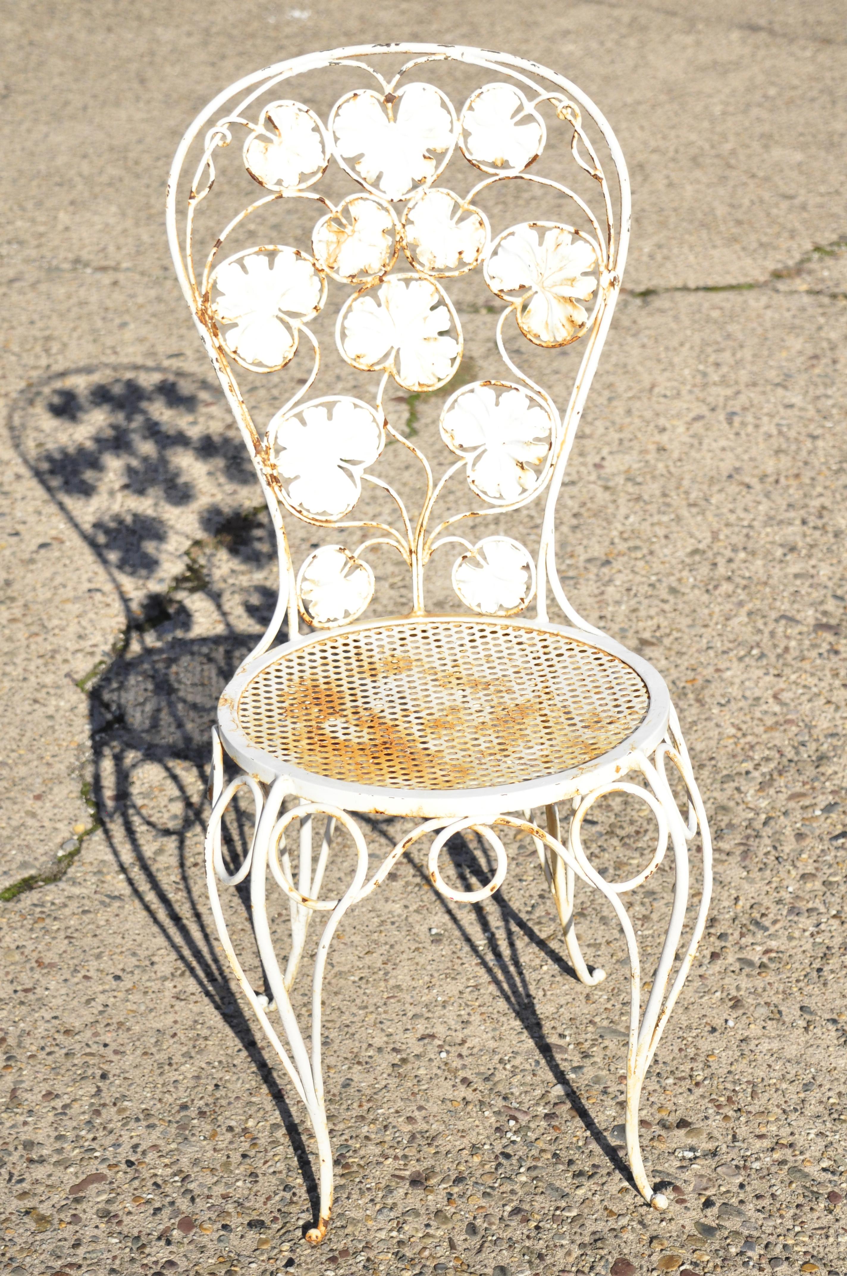 Antique French Art Nouveau flower maple leaf wrought iron garden chairs - a pair. Item features (2) side chairs, maple leaf backs, round perforated mesh seats, wrought iron construction, very nice antique item, great style and form, circa early