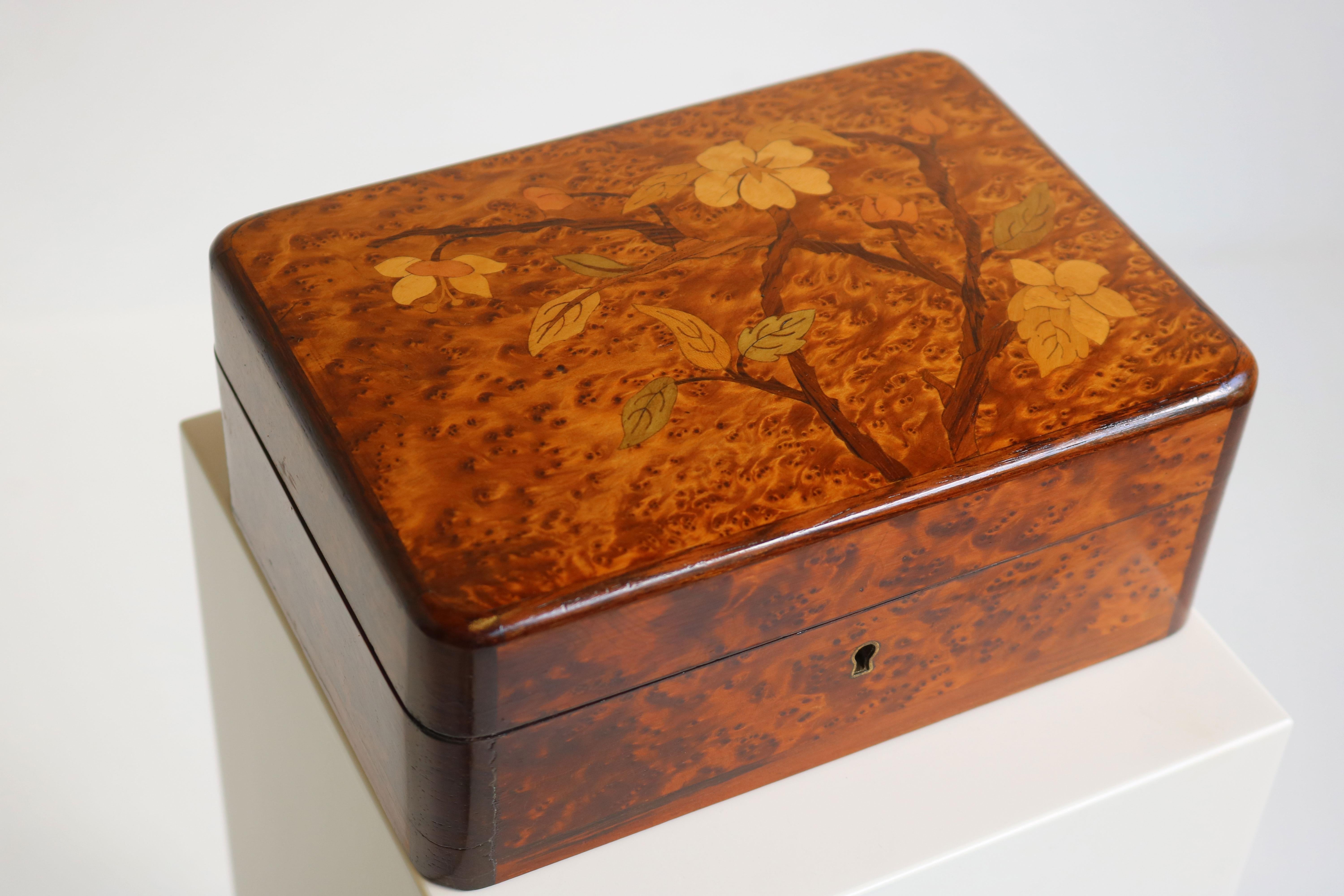 Gorgeous & rare! This French Art Nouveau Jewelry box made from Burl wood with floral inlay decorations. 
The jewelry box looks amazing from all angles, made with great care & craftsmanship. 
The original finish on the Burl wood is amazing and the