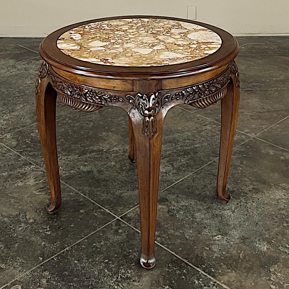 Antique French Art Nouveau Marble Top Walnut Round End Table is a delightful example of fine French craftsmanship, with perfect proportions, a round shape, and loads of flair and charm!  Crafted from solid, sumptuous walnut, it features a Brescia