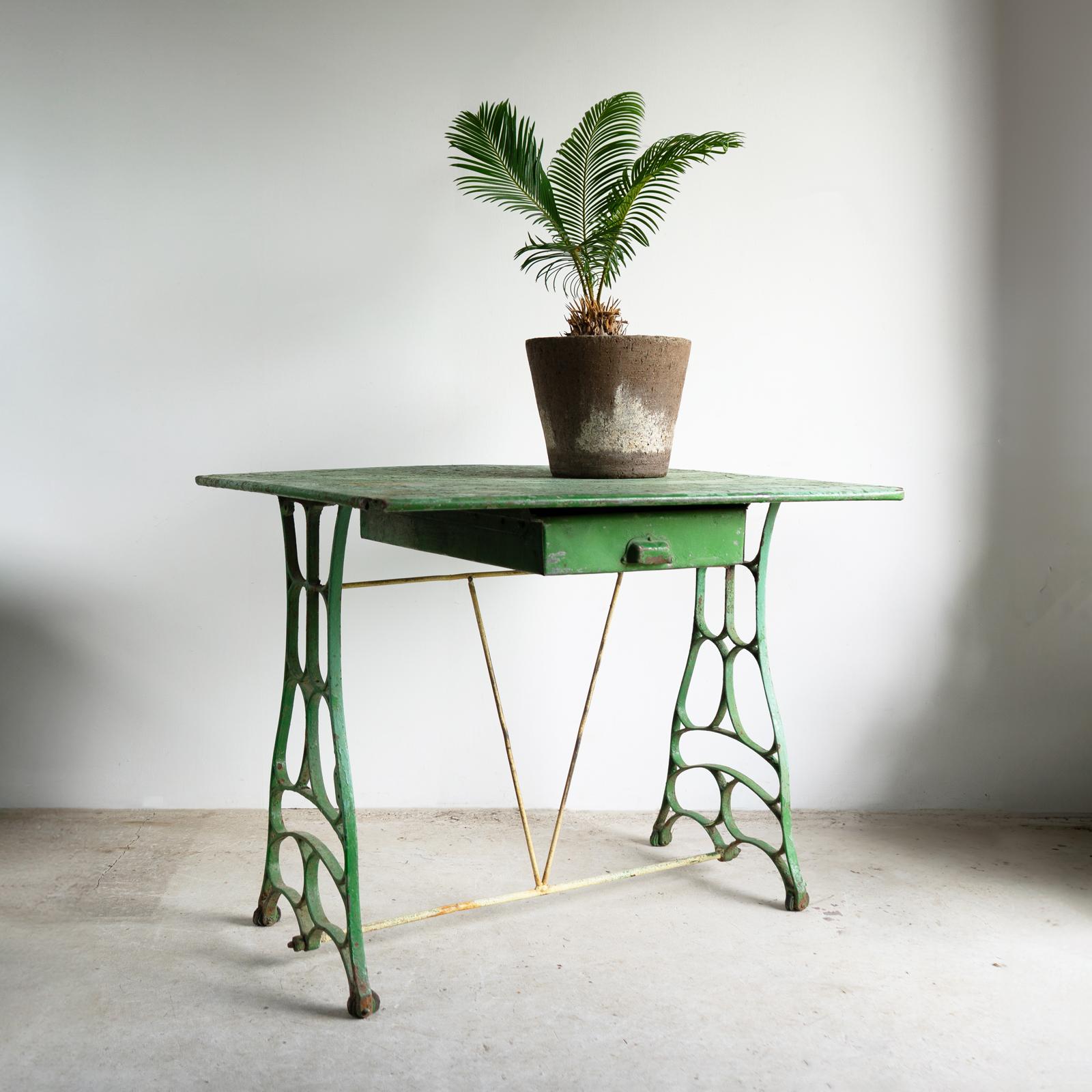 ANTIQUE FRENCH TABLE

A highly decorative and useful metal table.

The cast-iron base is organic in form, slightly reminiscent of the architecture of the Paris Métro.

The galvanised zinc top is rectangular with a useful zinc drawer underneath,