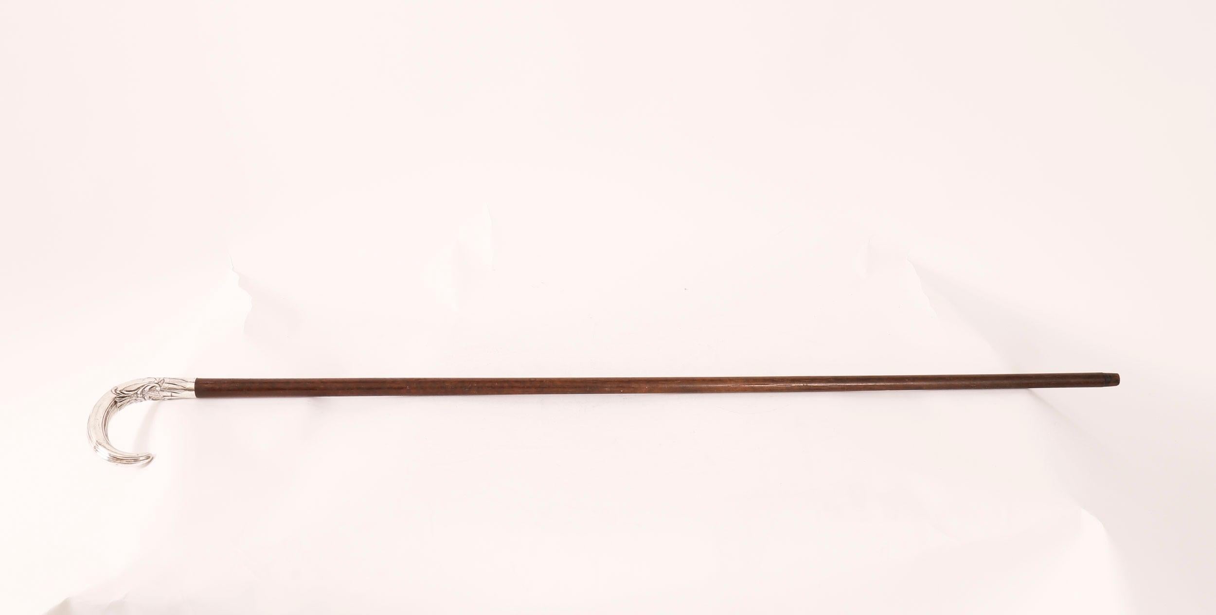 This is a fantastic antique French Art Nouveau silver topped walking stick, Circa 1900 in date.

The striking stick features an ornate silver crook head handel, on a gentle tapering hardwood shaft, the handle is decorated with chased with flowers