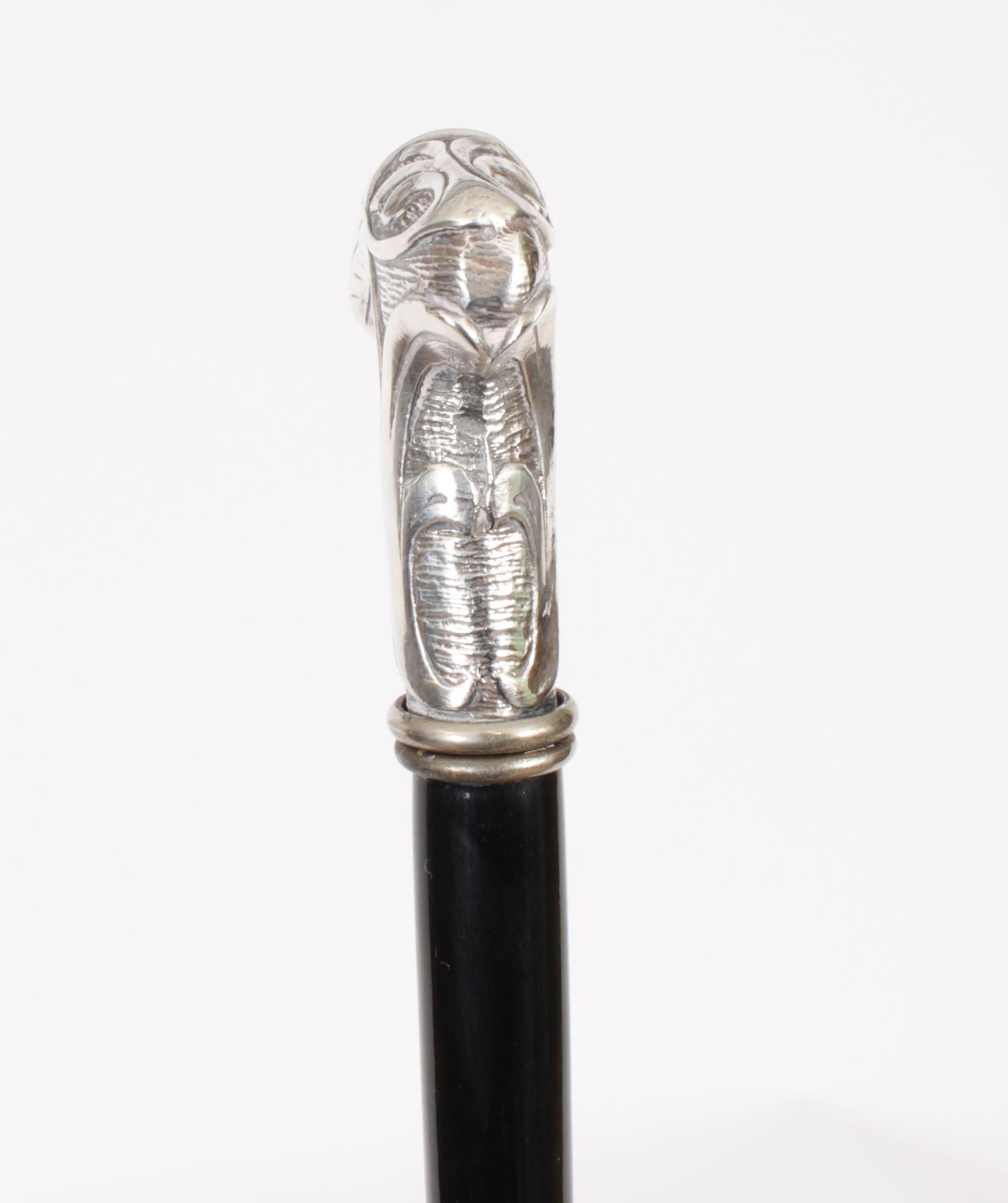 This is a beautiful antique French Art Nouveau silver walking stick, circa 1890 in date

The striking stick features an ornate silver Crutch handle with a profusely embossed stylized floral design, on a gentle tapering ebonized shaft and it  has its