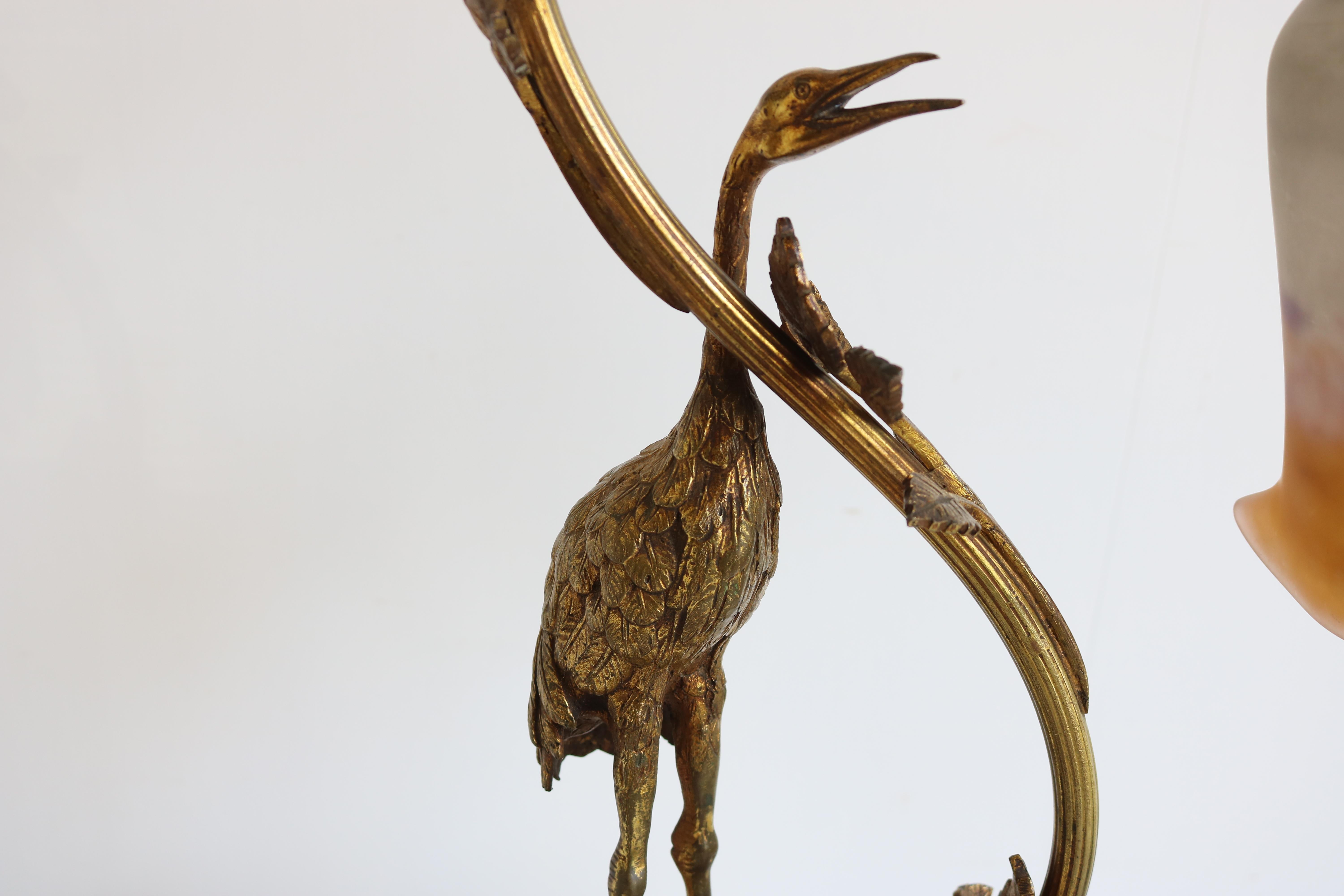 Exquisite Art Nouveau desk lamp rare & early design by David Guéron Degué France 1920. 
Bronze art nouveau frame with a Heron & floral branches / leaves combined with a hand made ''Pate de verre'' art glass shade signed by Degué. 
The shade is