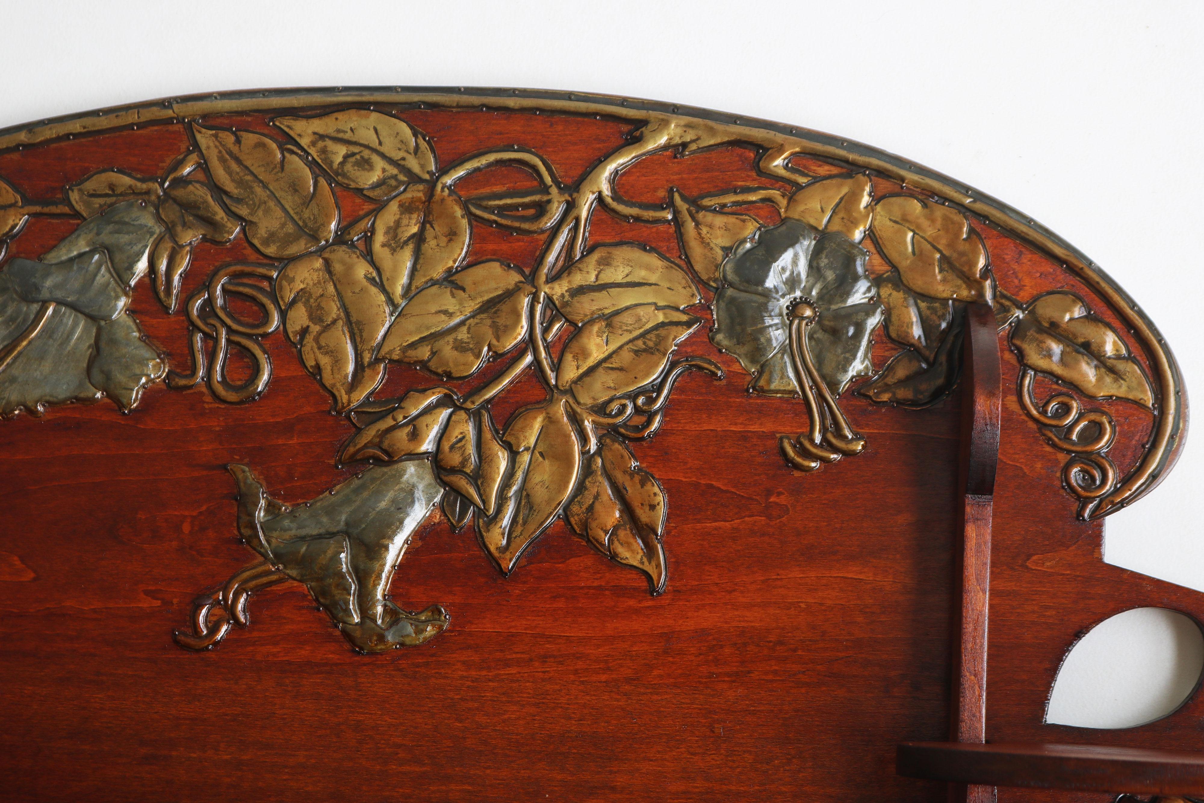Gorgeous & rare! This French art nouveau wall shelf made out of cherry wood & decorated with hammered brass ''morning glory flowers''. 
Fully made by hand and attached to the wood with small brass nails. Exquisite piece of craftsmanship that looks
