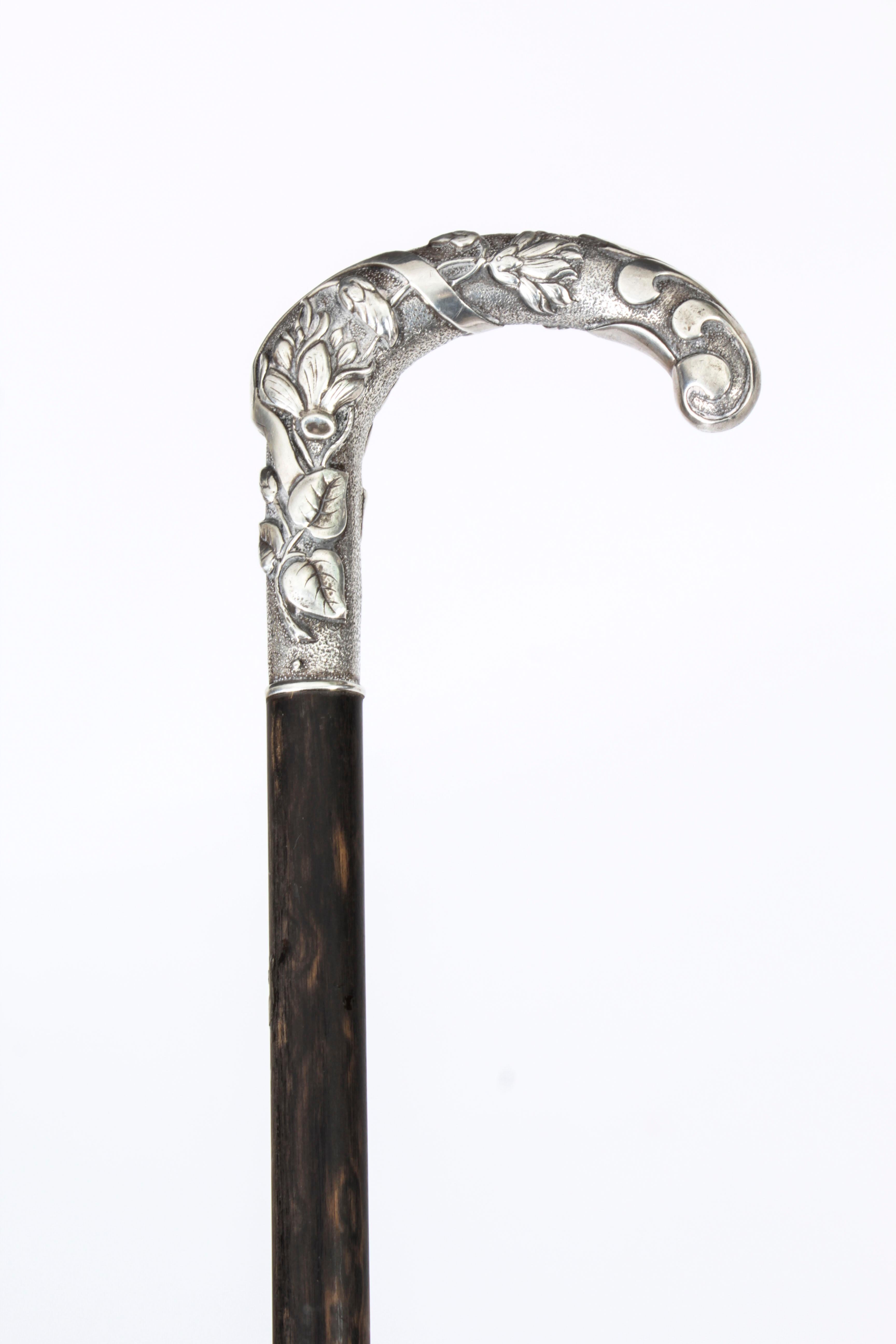 This is a fantastic antique French Art Noveau silver handled and ebonized walking stick, circa 1890 in date.
 
It has a very decorative silver hook handle decorated with foliate ornamentation which is cast with great attention to detail with a