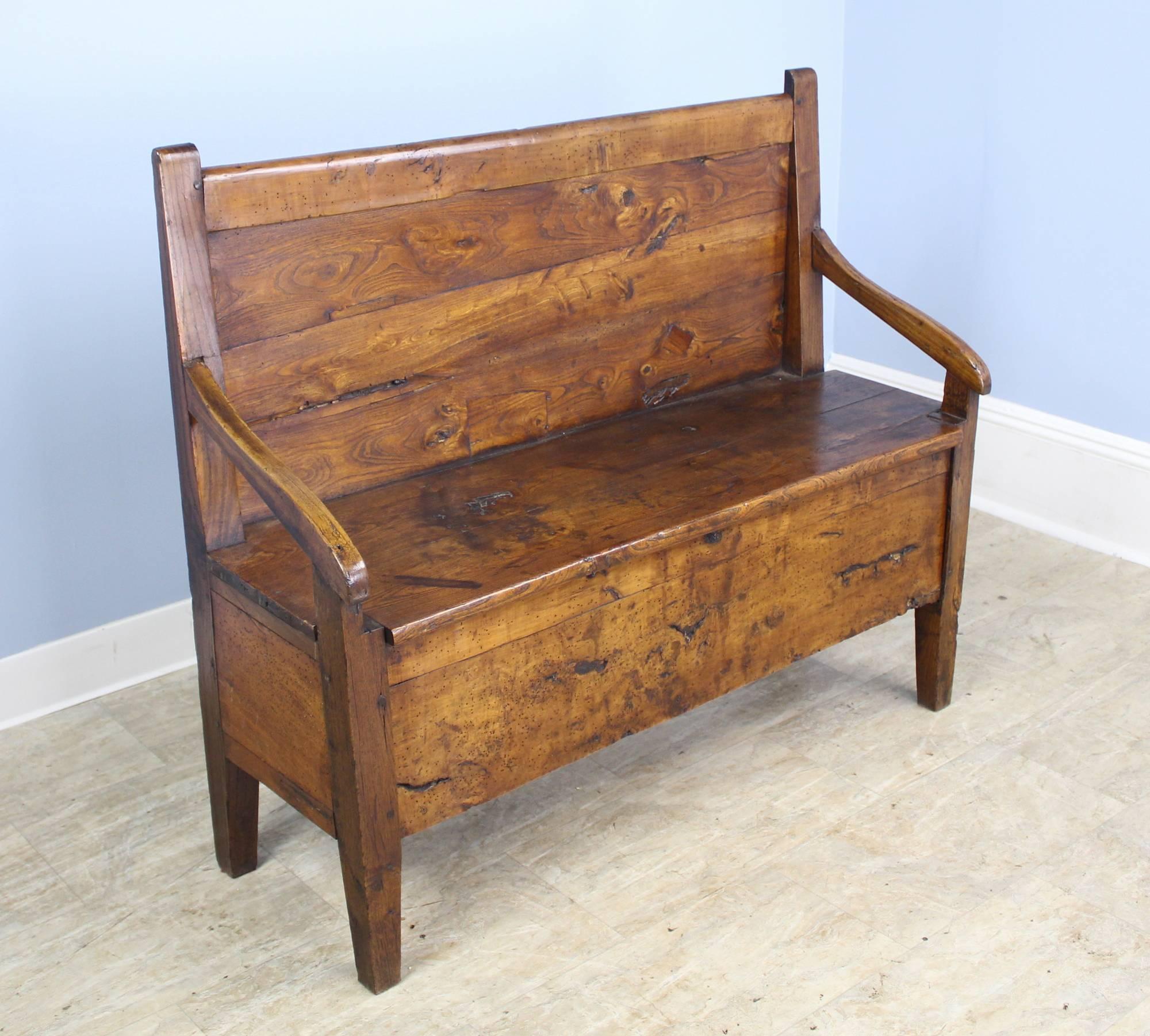 This country ash bench has some of the most spectacular grain we have seen! A simple Silhouette with a high back and gently sloping arms. The small drawer at one end of the seat adds a nice design note. Wonderful patina and color. Height measurement