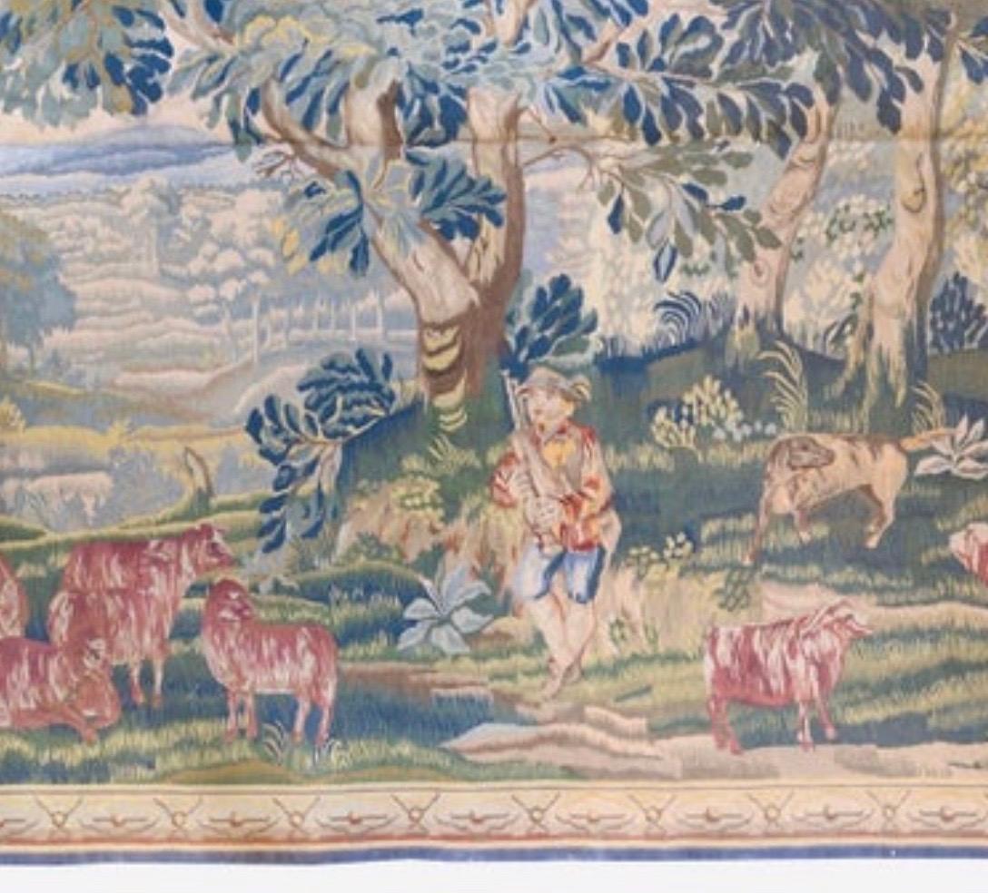 This is a lovely antique early 20th century French Aubusson landscape tapestry depicting a young man and animals in a lush landscape.

It is a classic example of the French Aubusson style and measures 7.5 x 9.6 ft.

Provenance: 
Christie's