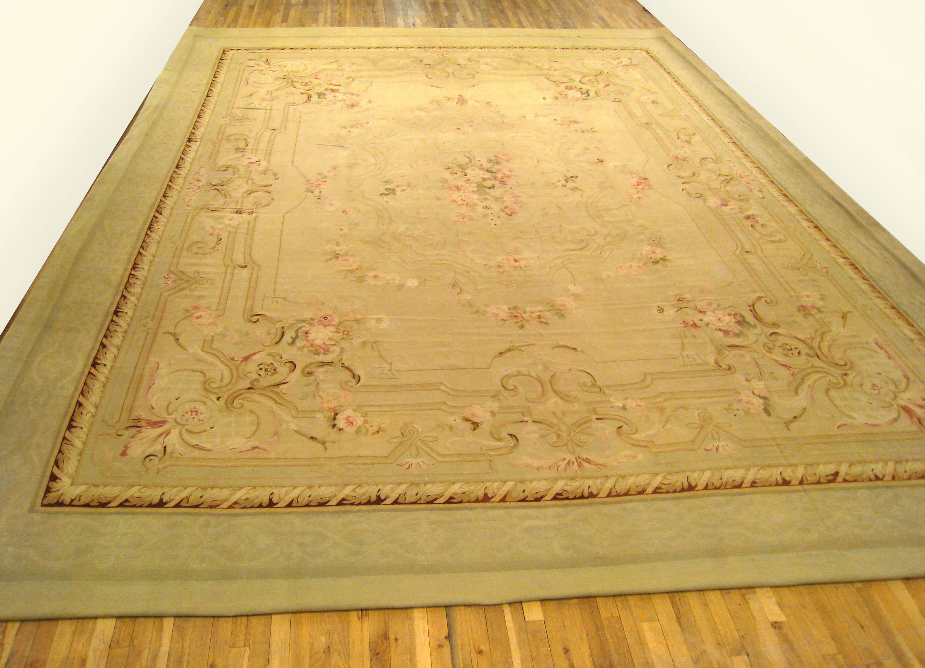 An antique French Aubusson 'Louis Philippe' carpet, circa 1880, size 19'2 x 15'0. This classic flat-woven carpet features an elegant central medallion in a softly hued primary field, and is enclosed within a sumptuous floral border. Composed of 100%