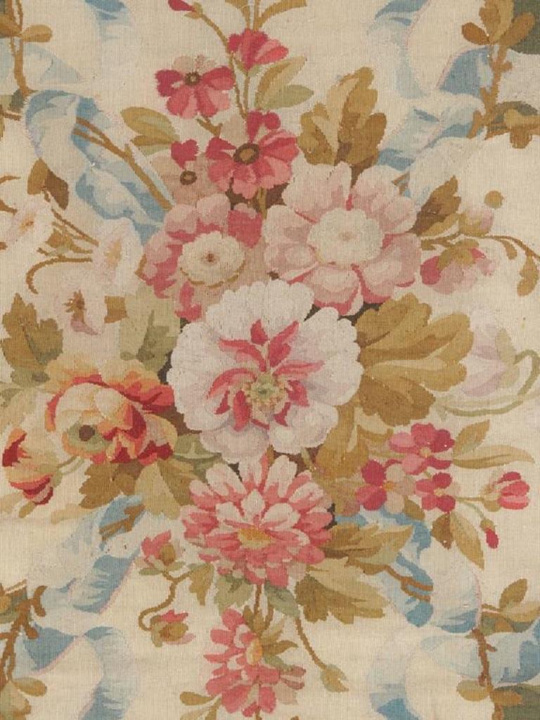 An antique circa 1850 French Aubusson rug 8'6x13'8. The central ivory medallion with wonderfully detailed floral emblems sits on a green field enclosed by a wonderful encroaching border. The Aubusson workshops, on the river Creuse in France, are