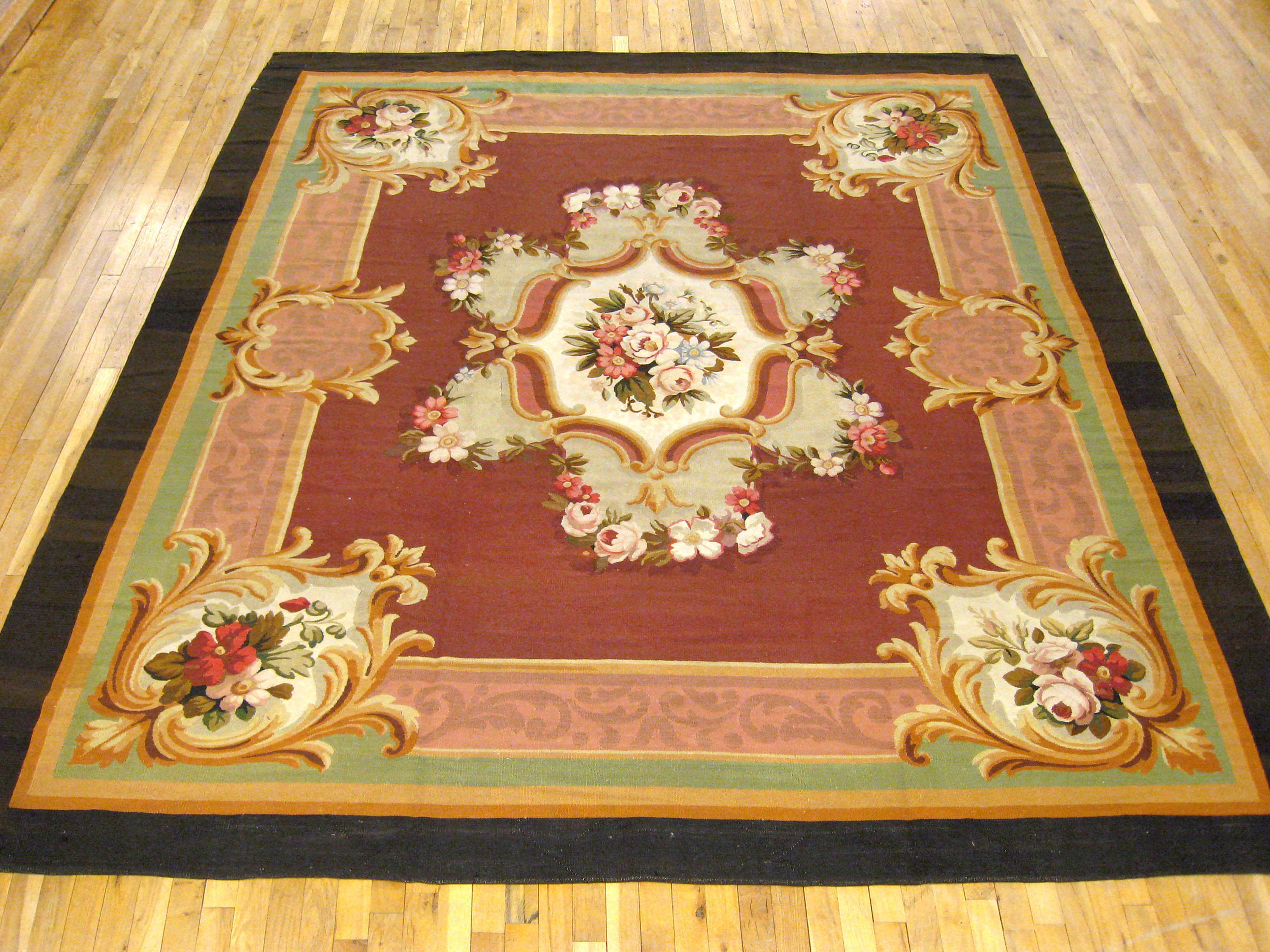 Antique French Aubusson rug, Room size, circa 1880

A one-of-a-kind antique French Aubusson Carpet, hand-knotted with soft wool pile. This lovely hand-knotted wool rug features a central medallion on the red primary field, with a delicate black