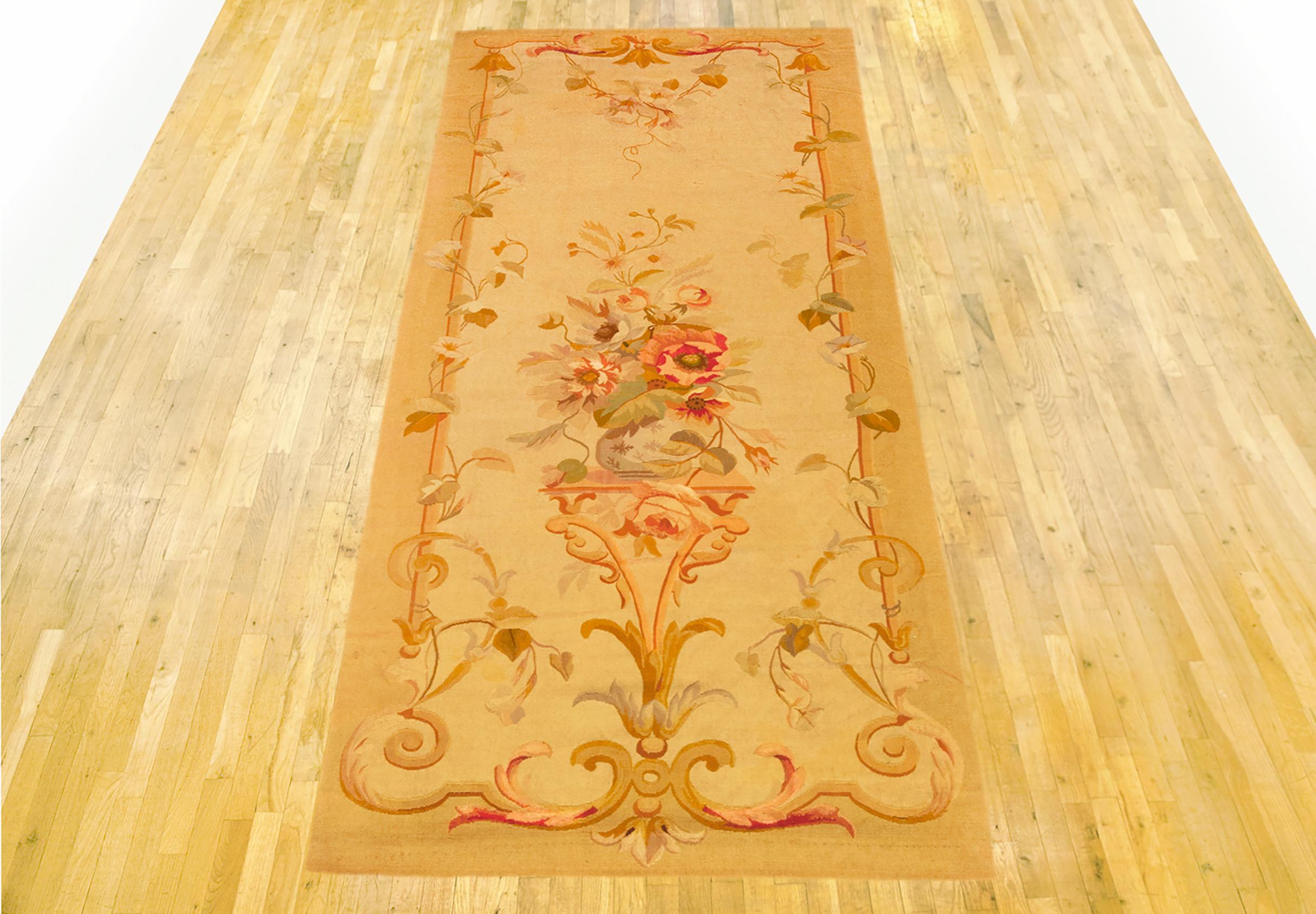 Antique French Aubusson Rug, Runner size, circa 1890

A one-of-a-kind antique French Aubusson Carpet, hand-knotted with soft wool pile. This lovely hand-knotted wool rug features a central medallion design on the beige primary field, with a delicate