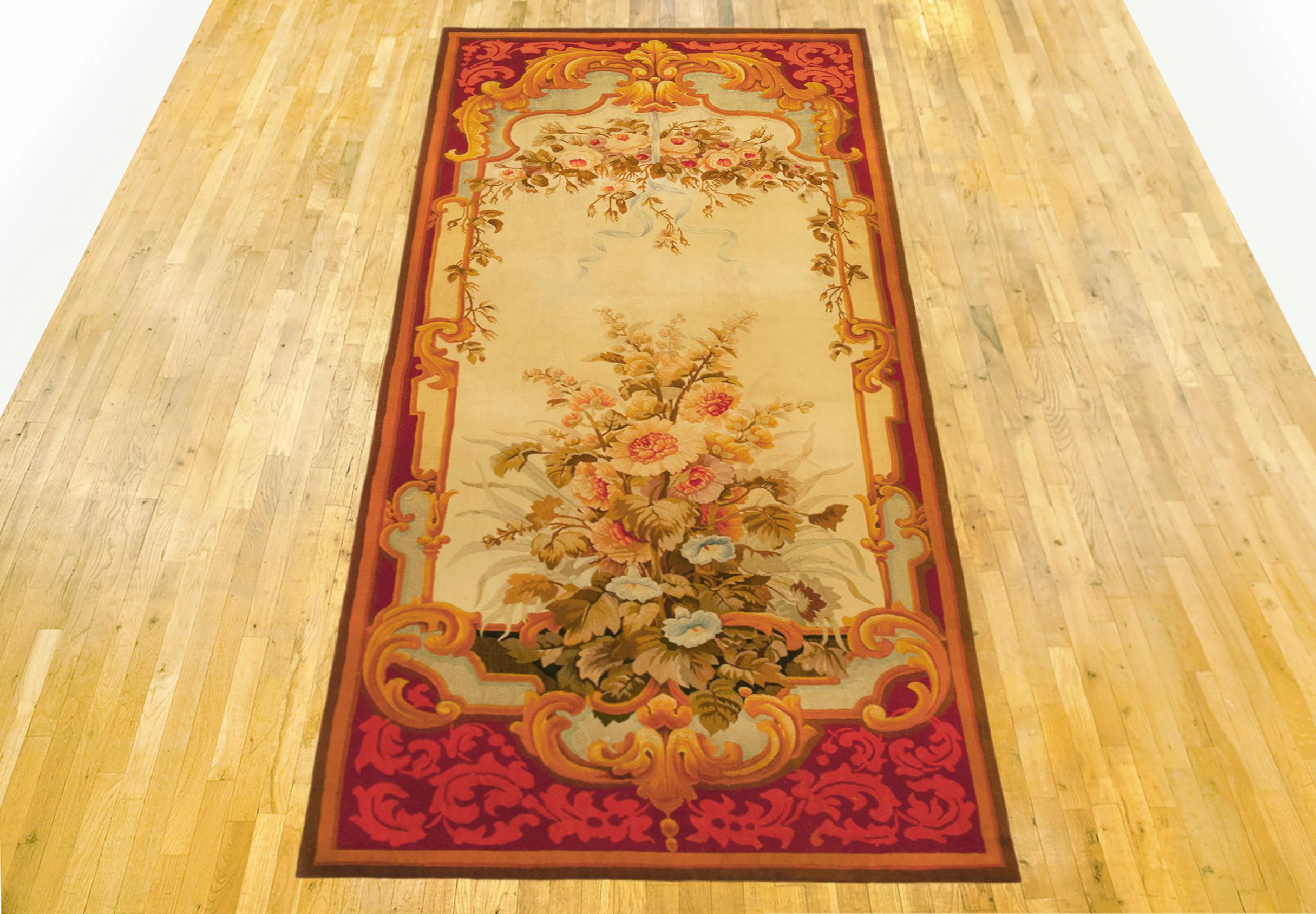 Antique French Aubusson Rug, Runner size, circa 1890

A one-of-a-kind antique French Aubusson Carpet, hand-knotted with soft wool pile. This lovely hand-knotted wool carpet features floral elements in a directional design on the ivory primary field,
