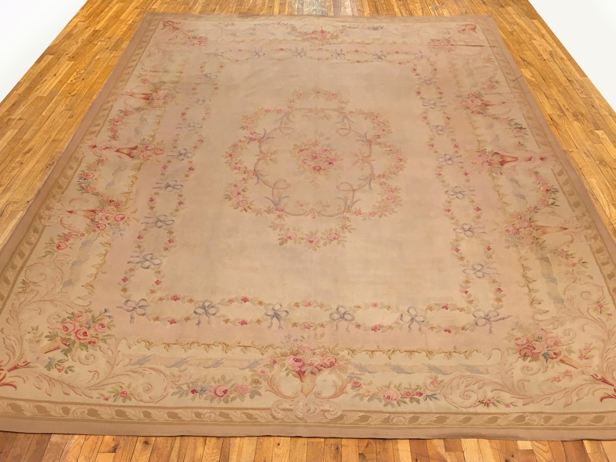 Antique French Aubusson Rug, Room size, circa 1890

A one-of-a-kind antique French Aubusson Carpet, hand-knotted with soft wool pile. This lovely hand-knotted rug features a central medallion design on the ivory primary field, with a delicate ivory