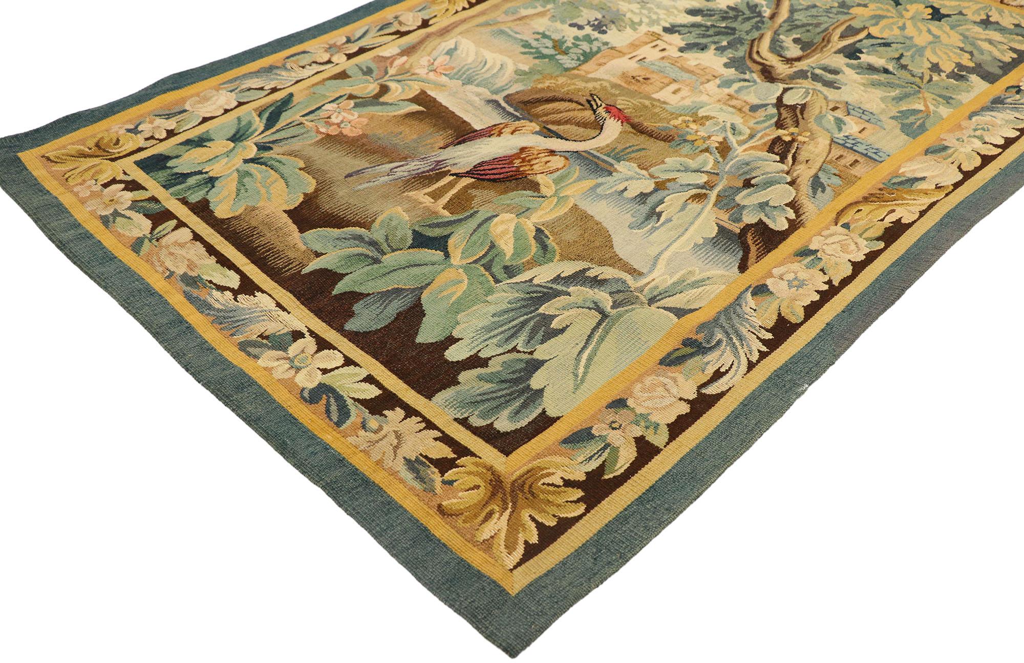 77764, antique French Verdure tapestry. This hand-woven antique French Aubusson verdure tapestry depicts a landscape scene of the French countryside. Displaying dense foliage, greenery, fauna and flowers, this antique French tapestry portrays a