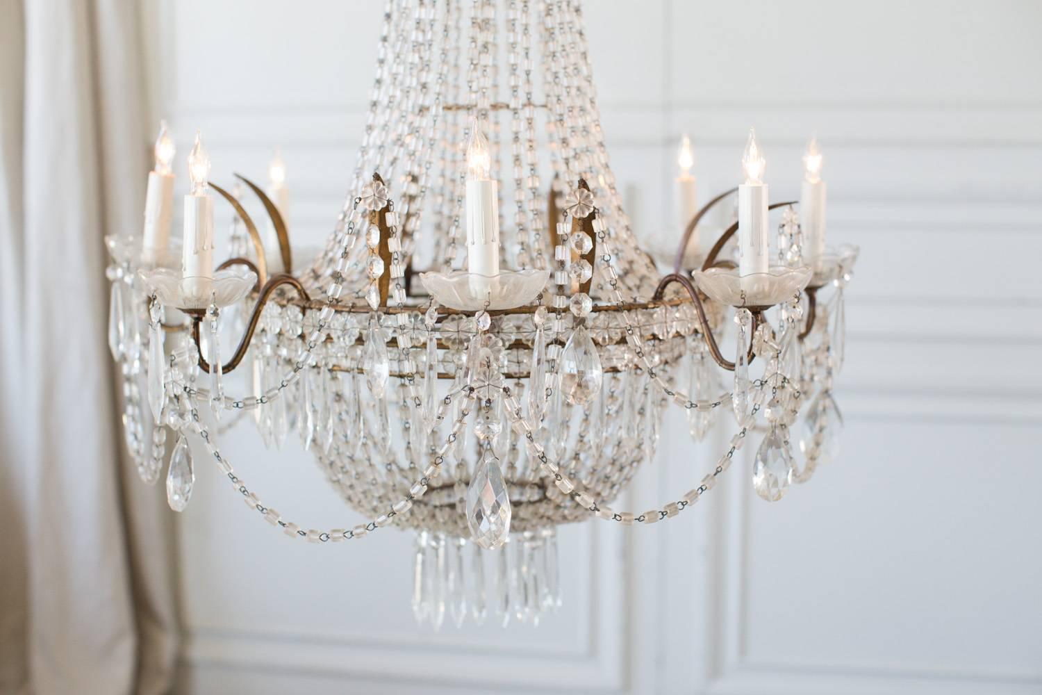 Gorgeous antique basket style chandelier with eight arms. A Cascade of glass beads gives this beautiful light shape and adds to the splendid presentation. Heavy faceted crystals are delicately mixed in lending perfection to this jewel. Hang above a
