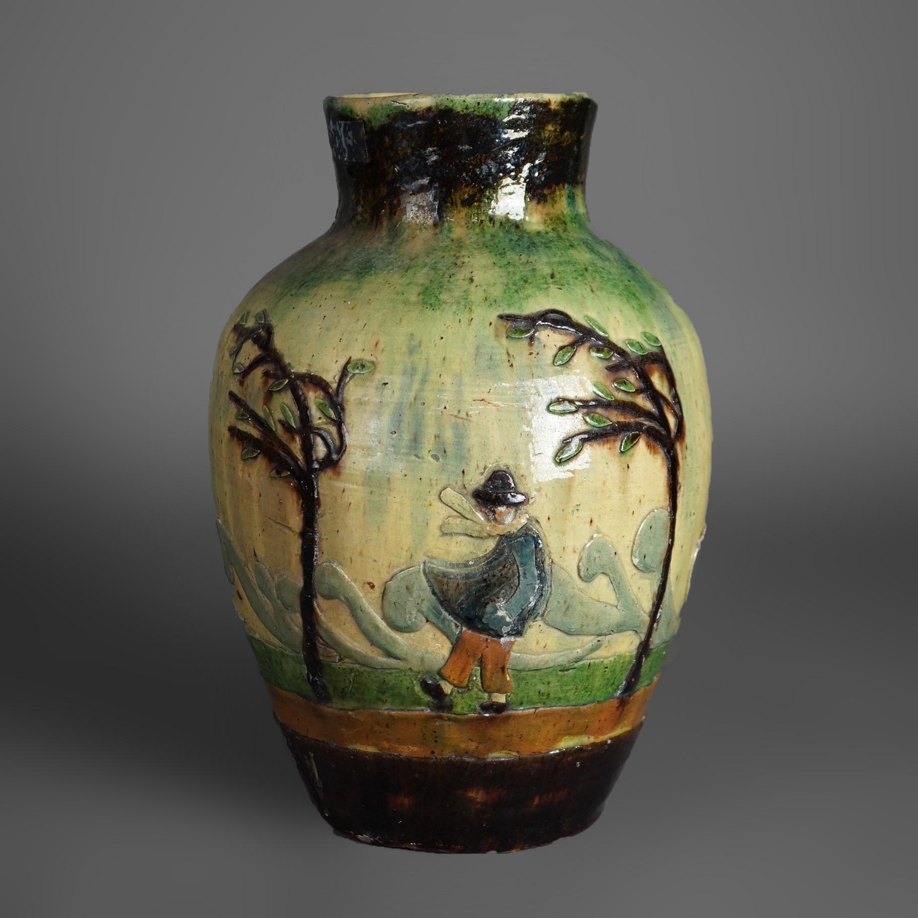 An antique French Barbotine vase offers pottery construction with outdoor scene with windswept trees and figures, c1890

Measures - 14.25