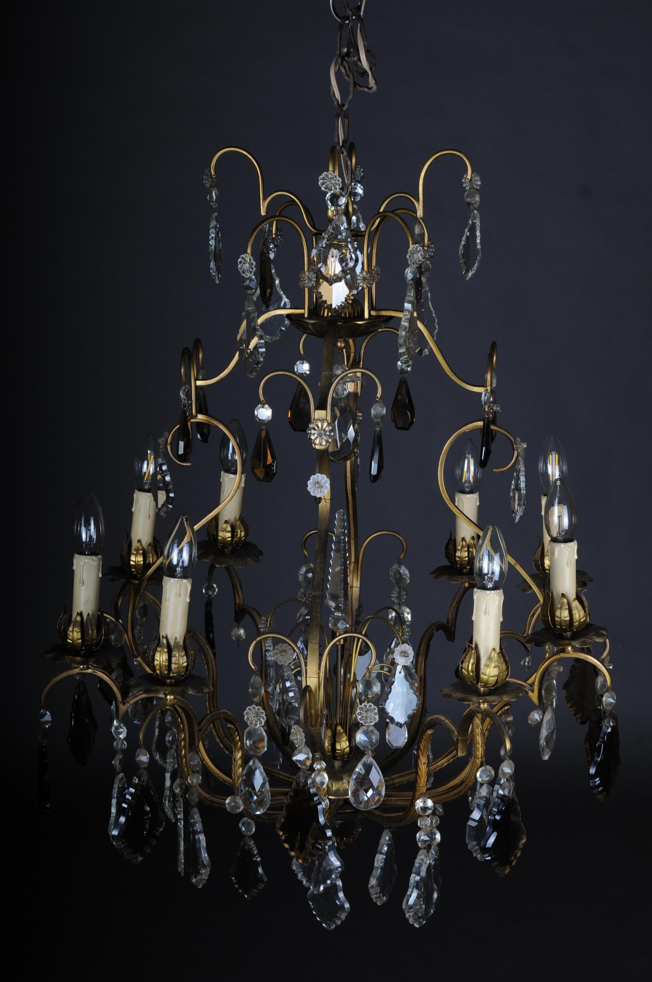 Antique French Baroque chandelier, circa 1930

Brass frame. Many curly basket rods. High baluster-shaped body with eight externally placed flames. Rich, ground hand-wired leaf prism hanging of varying size. Candle-shaped pods made of handcrafted