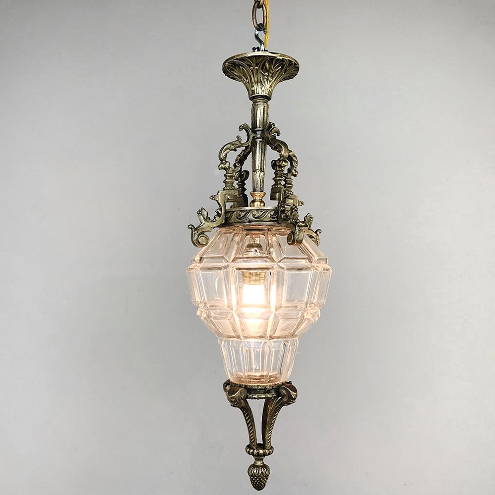 Antique French baroque crystal & bronze lantern chandelier features a faceted globe surrounded by intricately detailed cast bronze to create an opulent light fixture that is ideal for small entryways, hallways, or smaller rooms. Details include the