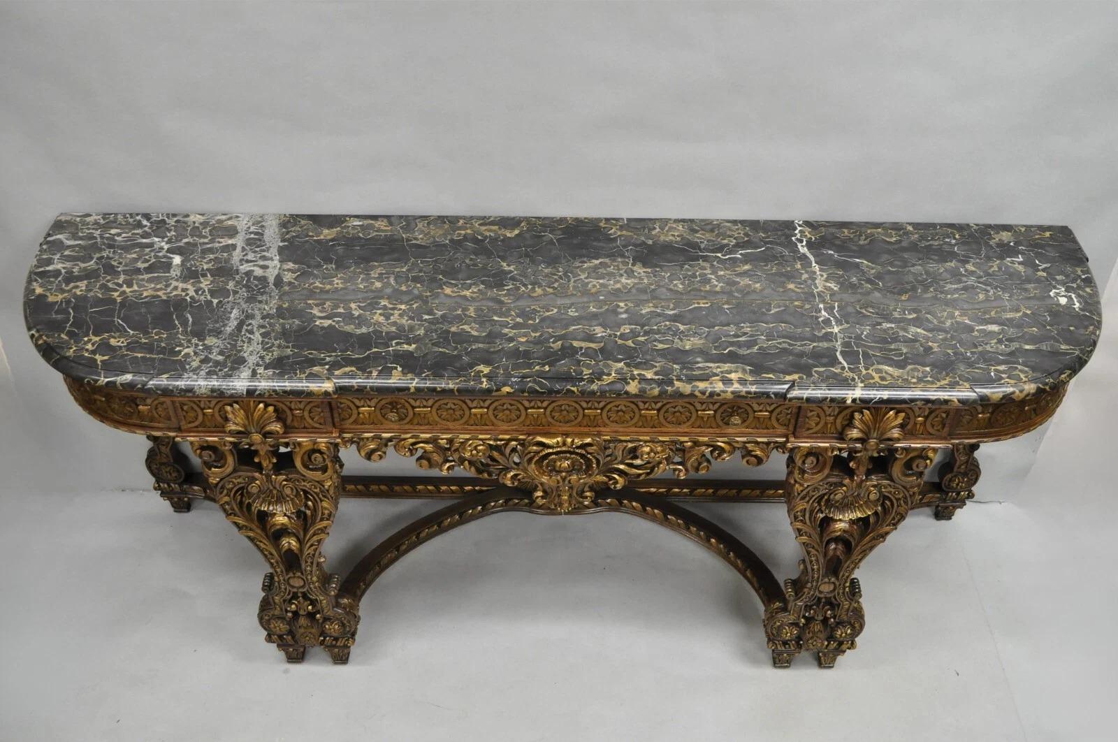 Antique French Baroque Rococo Style Ornately Carved Walnut Marble Top Long Sideboard Buffet with 3 Drawers. Item features a large stately form with carved stretcher base, thick black shaped marble top, and gold gilt details throughout. Highly