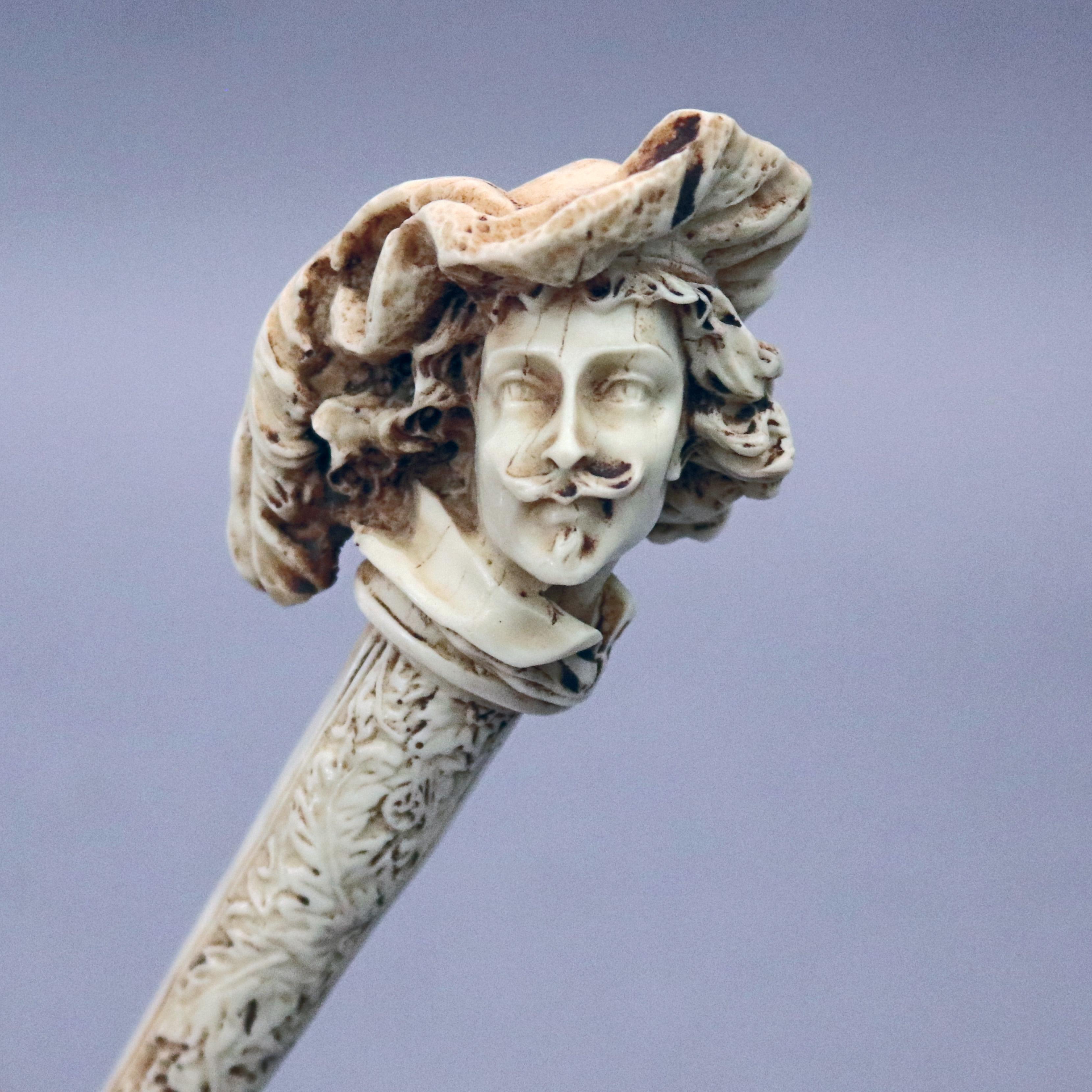 Ant antique French Baroque style figural magnifying glass offers handle with hand carved bone having floral and foliate design terminating in bust of Frenchman in hat, 19th century


Measures: 10