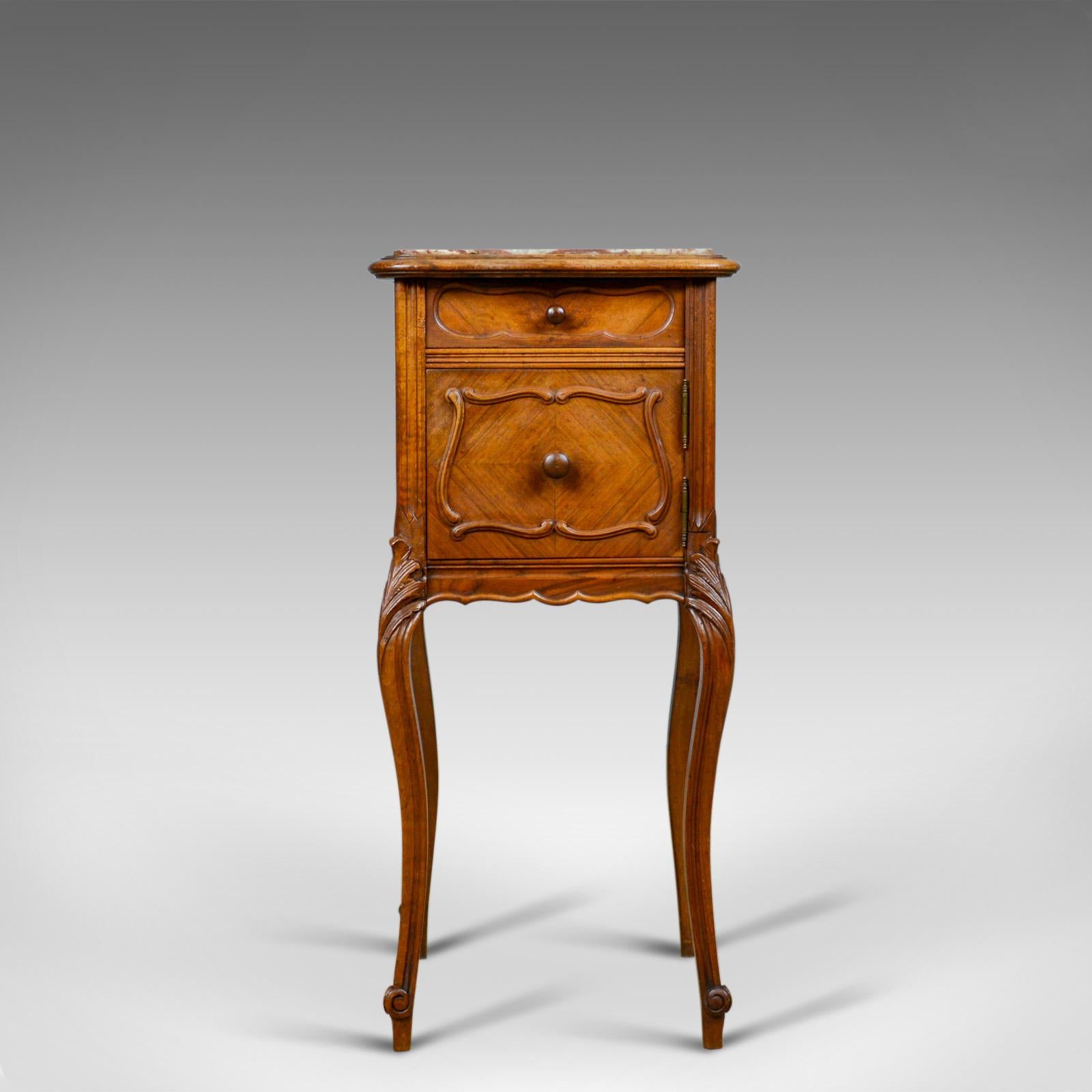 This is an antique French bedside cabinet. A Victorian, walnut, marble top, pot cupboard dating to circa 1890.

Elegant form in good proportion and of quality craftsmanship
Attractive tones to the walnut with a mellow wax polished finish
Well