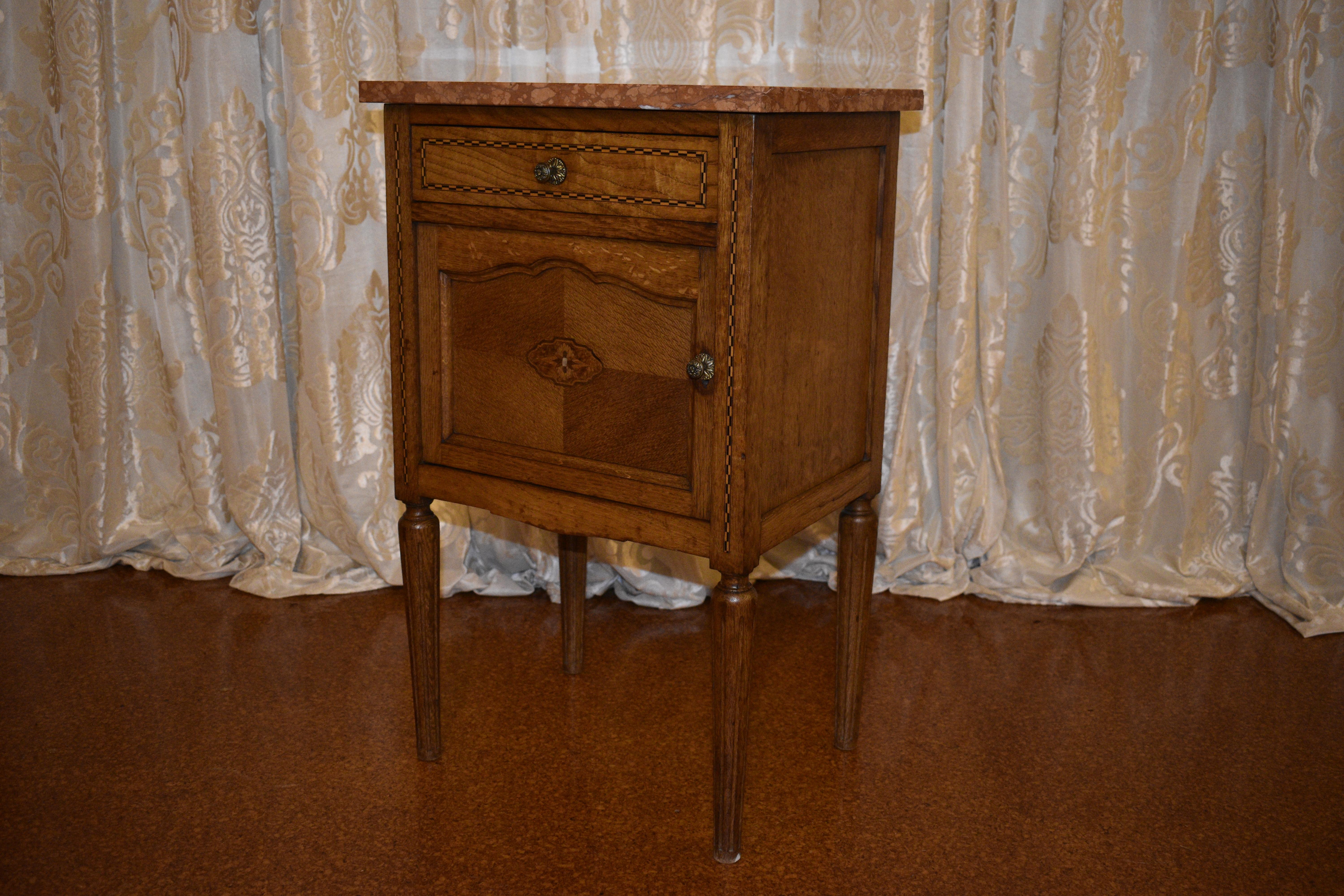 Marquetry inlay with mother of pearl centre, brass handles, marble top and tapered reeded legs. Tumbridge ware detail to cabinet.

Circa: 1890

Material: Oak and Marble

Country of Origin: France

Measurements: 74cm high, 46cm width, 35cm