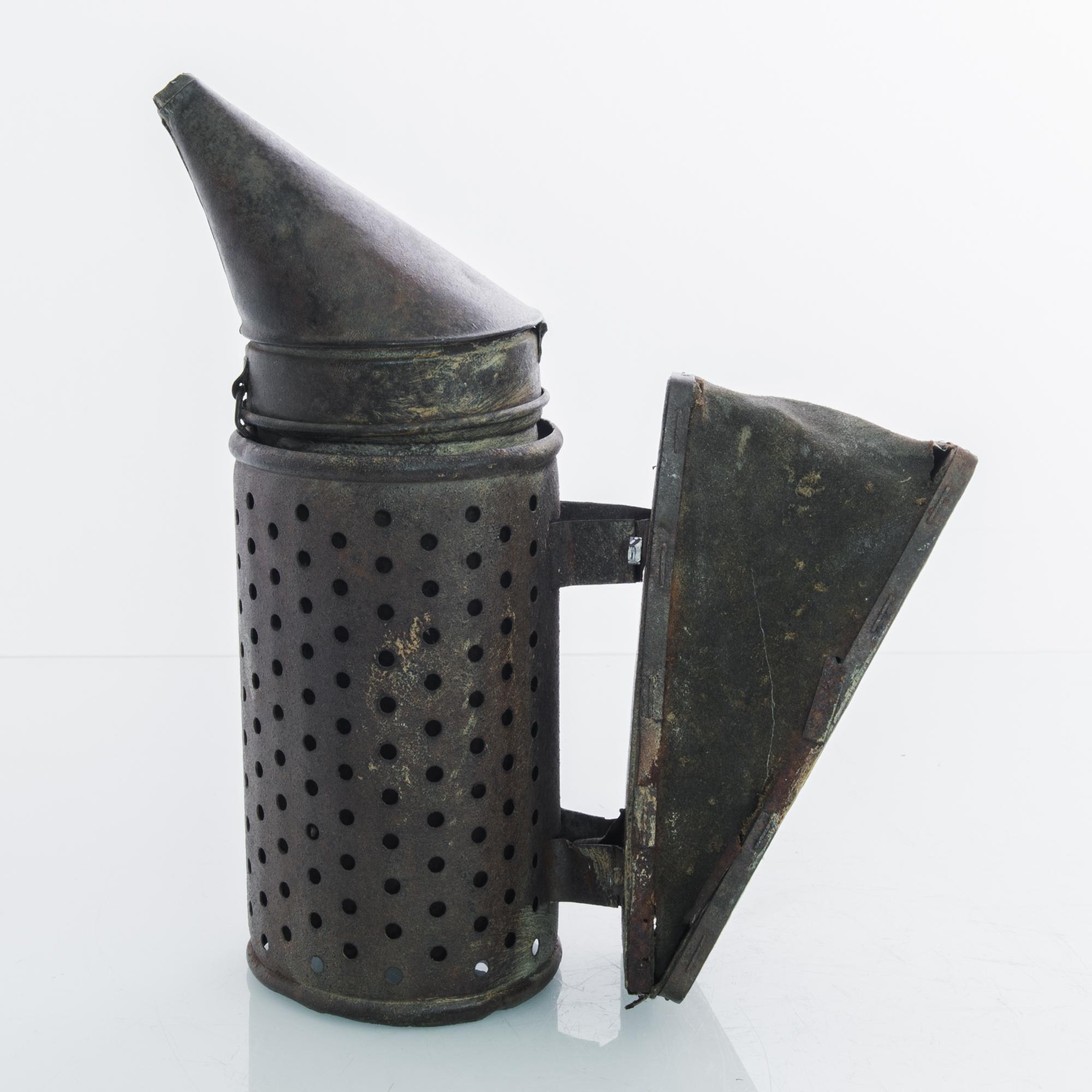 A metal bee smoker from France circa 1900. This apiarists’ bellows captivates with its wayward charm, a curious remembrance from another era.