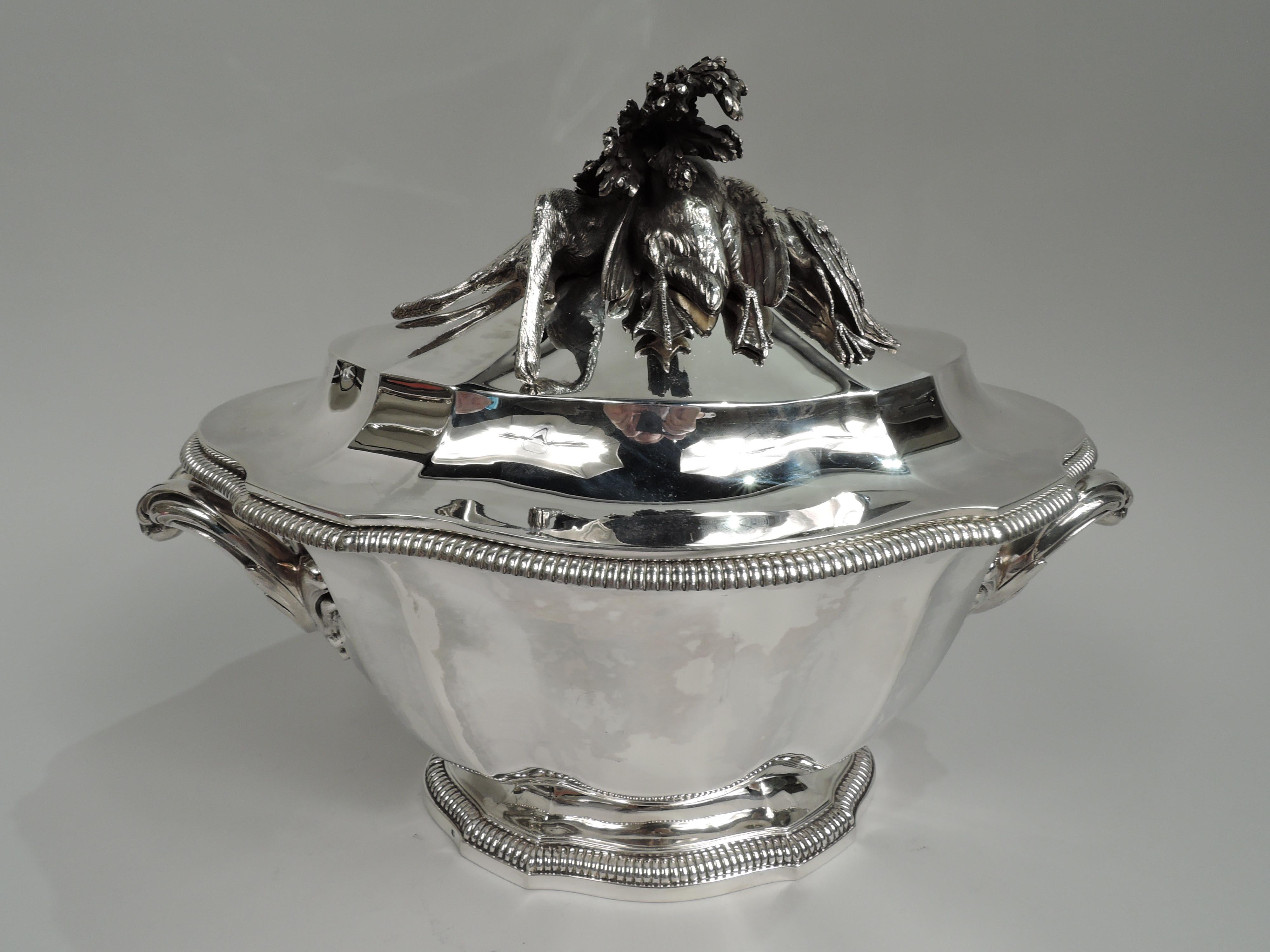 French Belle Epoque 950 silver tureen, ca 1910. Tapering oval curvilinear bowl on same raised foot with gadrooned rims. Leaf-mounted double c-scroll end handles. Raised cover. Restrained turn-of-the-century Classicism enlivened with a cast still