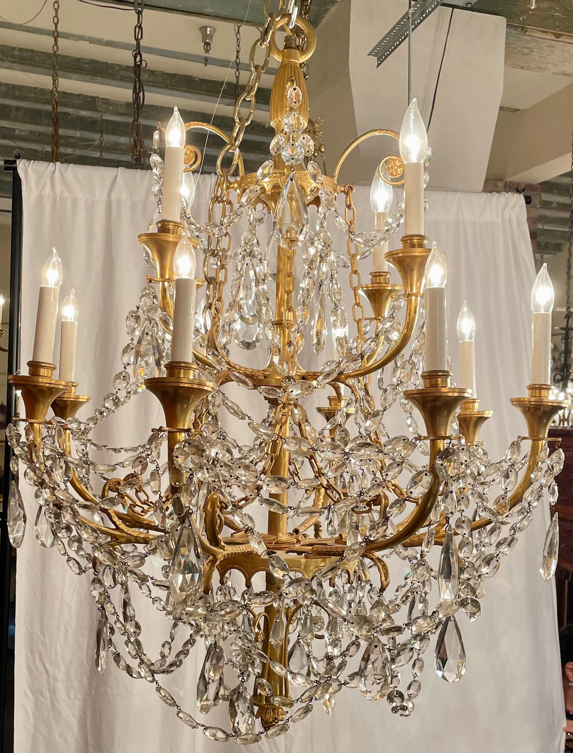 Antique French Belle Époque era gold bronze & heavily draped cut crystal 2-tier chandelier, circa 1910.