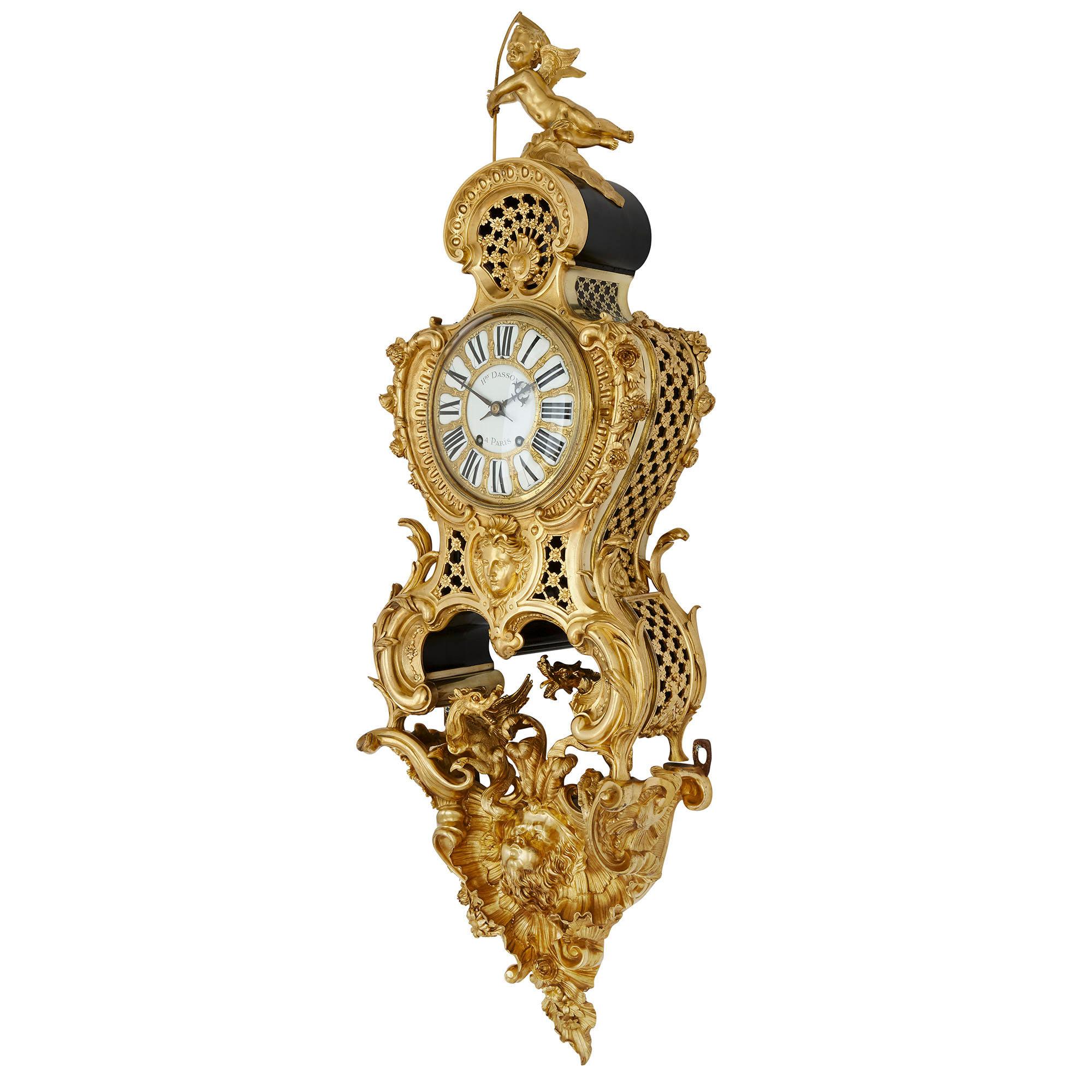 Antique French Belle Époque Rococo style bracket clock by Henry Dasson
French, 1882
Measures: Total height 136cm
Clock height 86cm, width 37cm, depth 18cm
Bracket height 50cm, width 38cm, depth 18cm

Beautifully crafted from ormolu, this