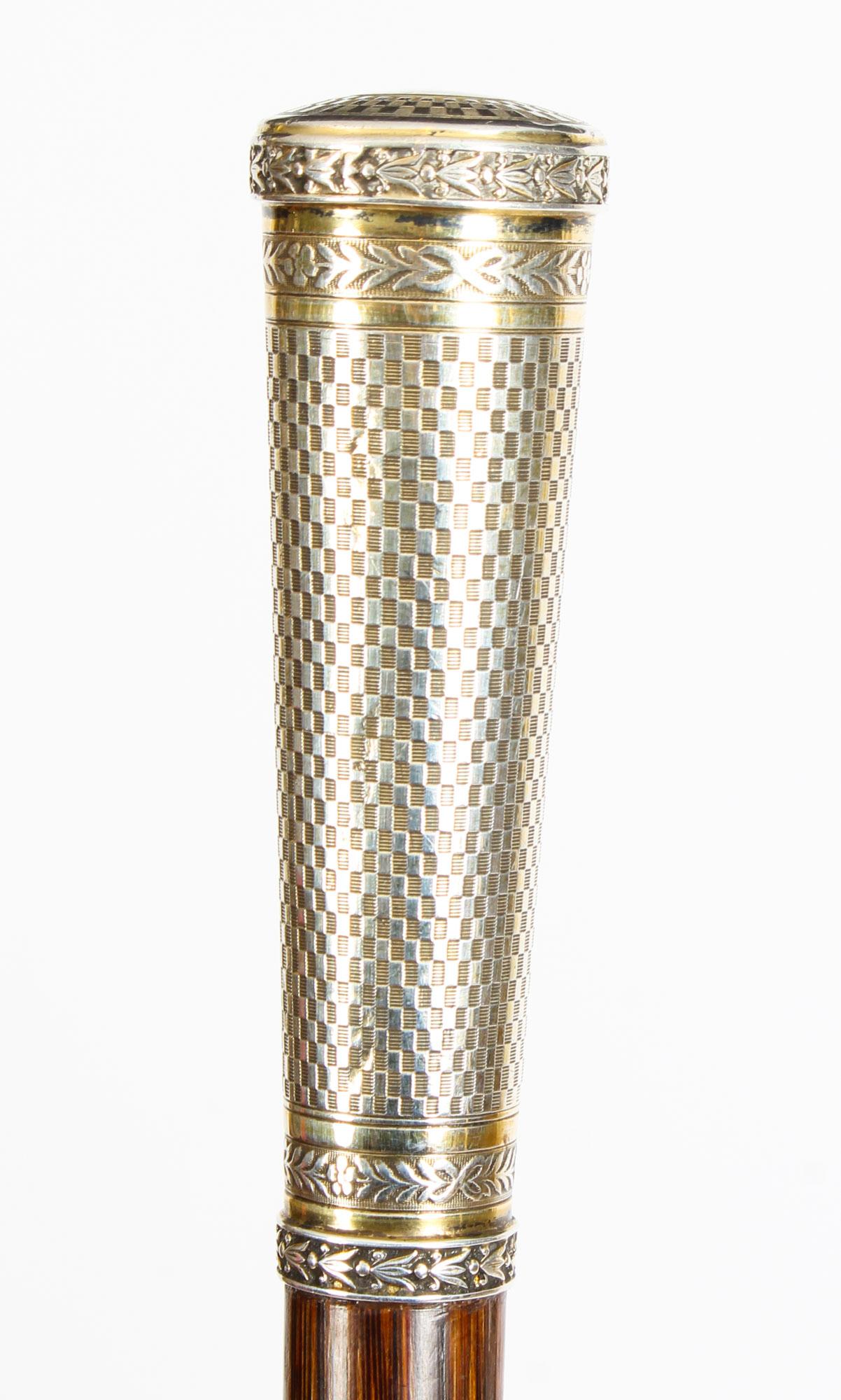 This is a superb antique French Belle Époque silver-mounted bamboo walking stick, with hallmarks for 1900.

This decorative walking cane features a splendid tapering cylinder handle chased with neoclassical leafy friezes between engine-turned