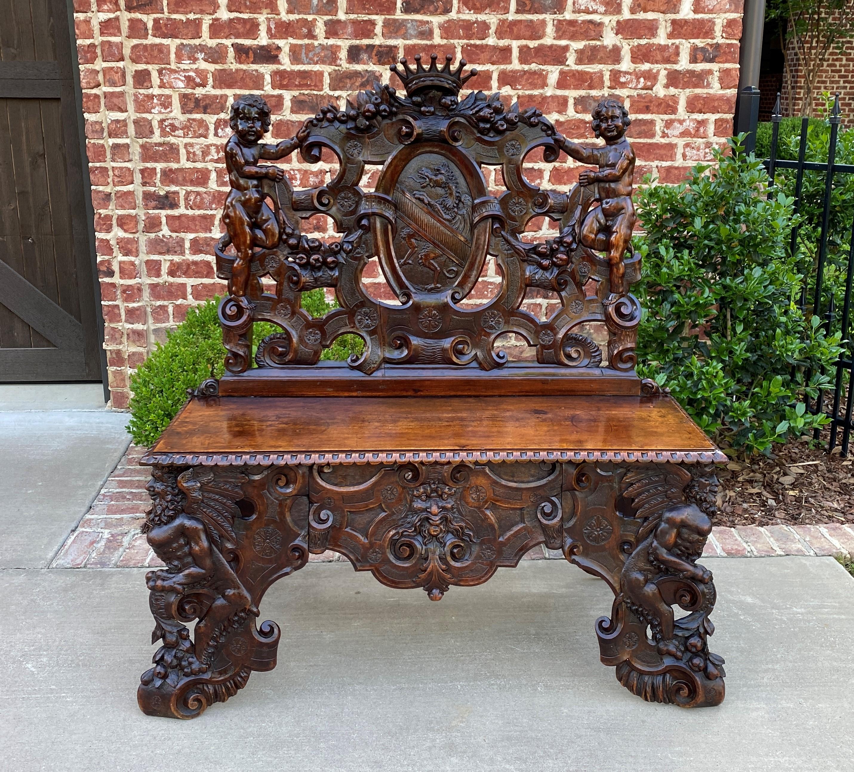 Exquisite antique French walnut Renaissance revival hall seat, bench or chair~~highly carved with Winged Griffon Cartouche and Cherubs~~c. 1880s 

Rare 19th century French hall seat, bench, settee, or chair~~rarely do we come across such a