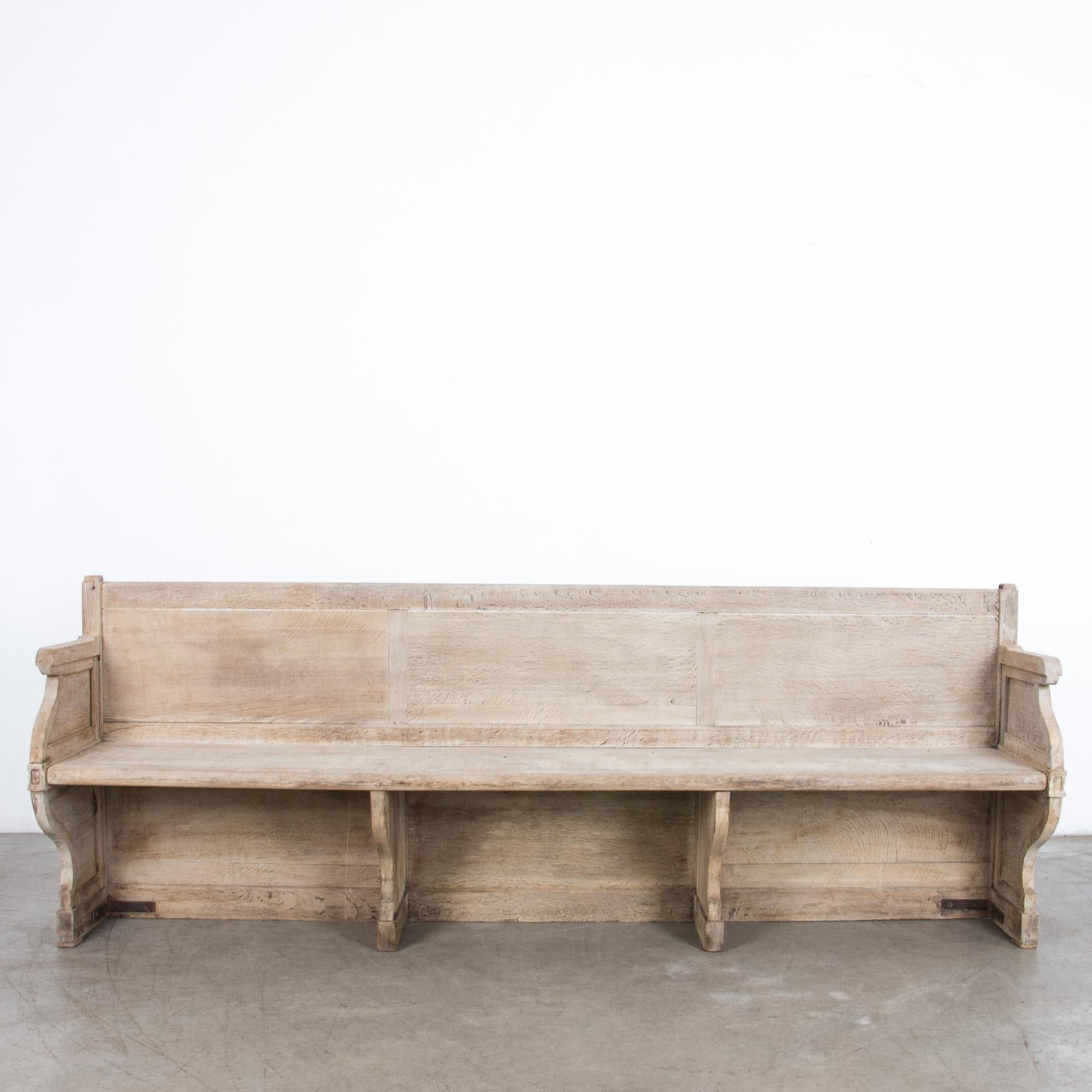 A late 19th century bench from France, circa 1880. Frame and panel construction gives this piece a durable structure and charming curved shape. Rustic texture is lightened and refreshed with an updated oil and wax finish. Detailed construction in