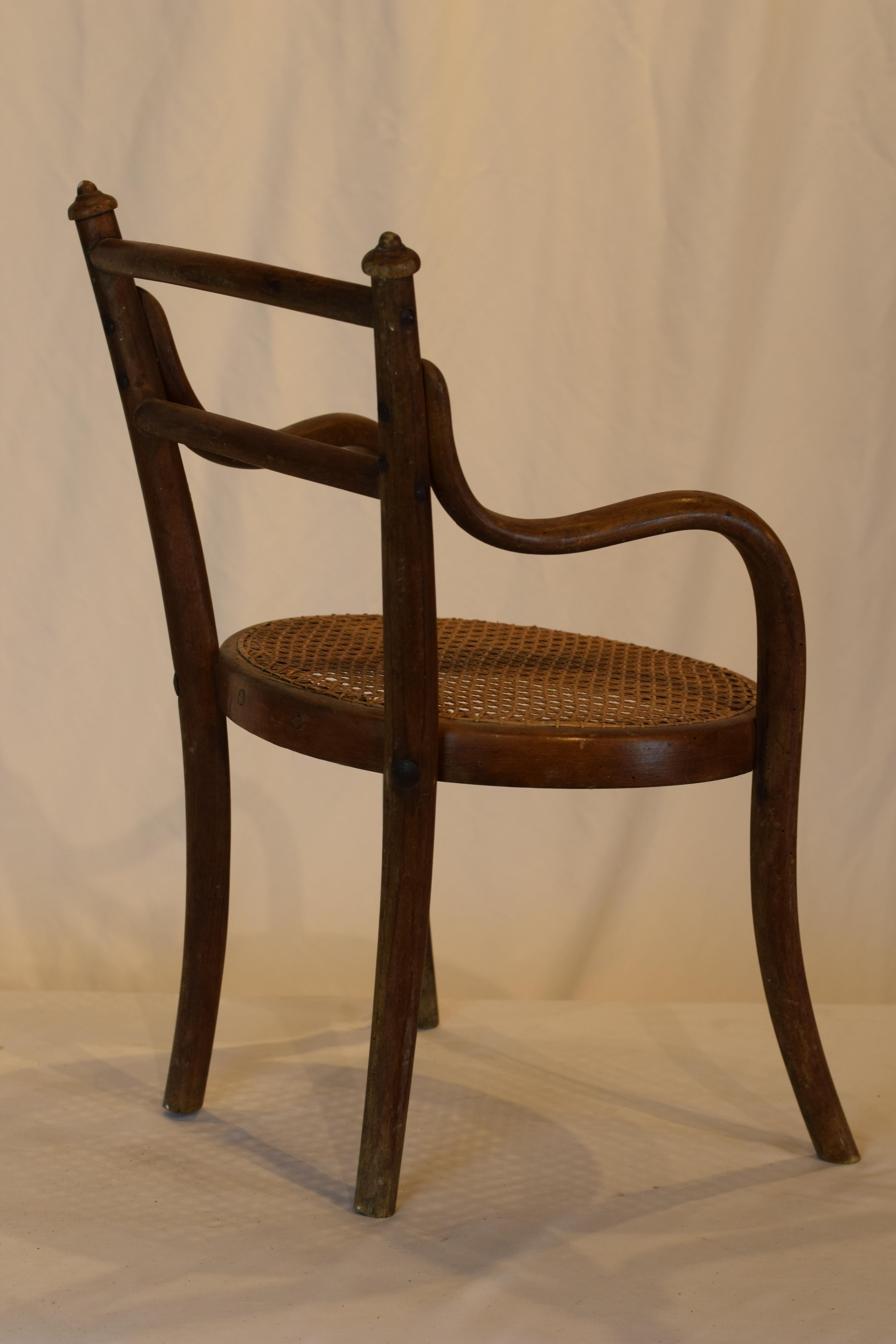 A truly wonderful child's bentwood and cane chair from France. Handmade with a cane seat, this would delight any child wanting his 'own chair' and would be charming just sitting alone beside the hearth. Beautiful bentwood and cane, this lovely piece