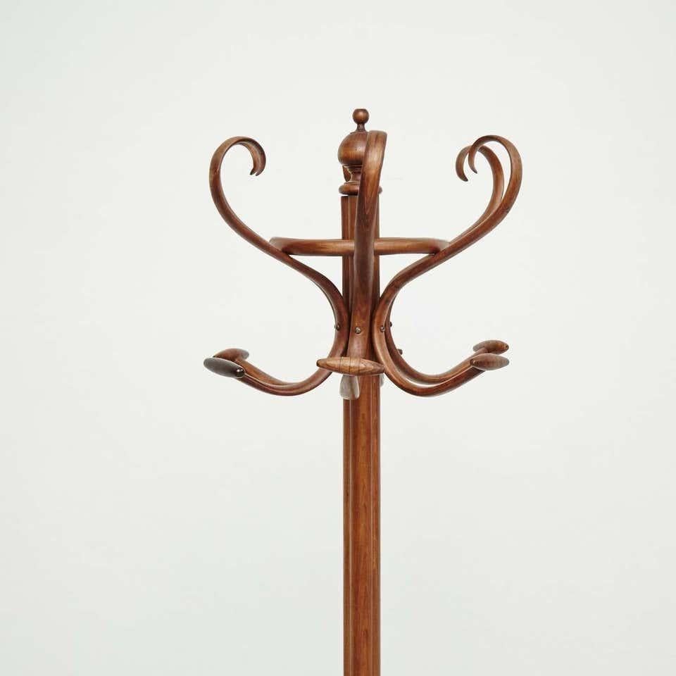 Antique French bentwood coat stand. By unknown artist, France, circa 1940. In original condition, with minor wear consistent with age and use, preserving a beautiful patina.   Materials: Wood  Dimensions: D 52 cm x W 58.5 cm x H 171 cm.