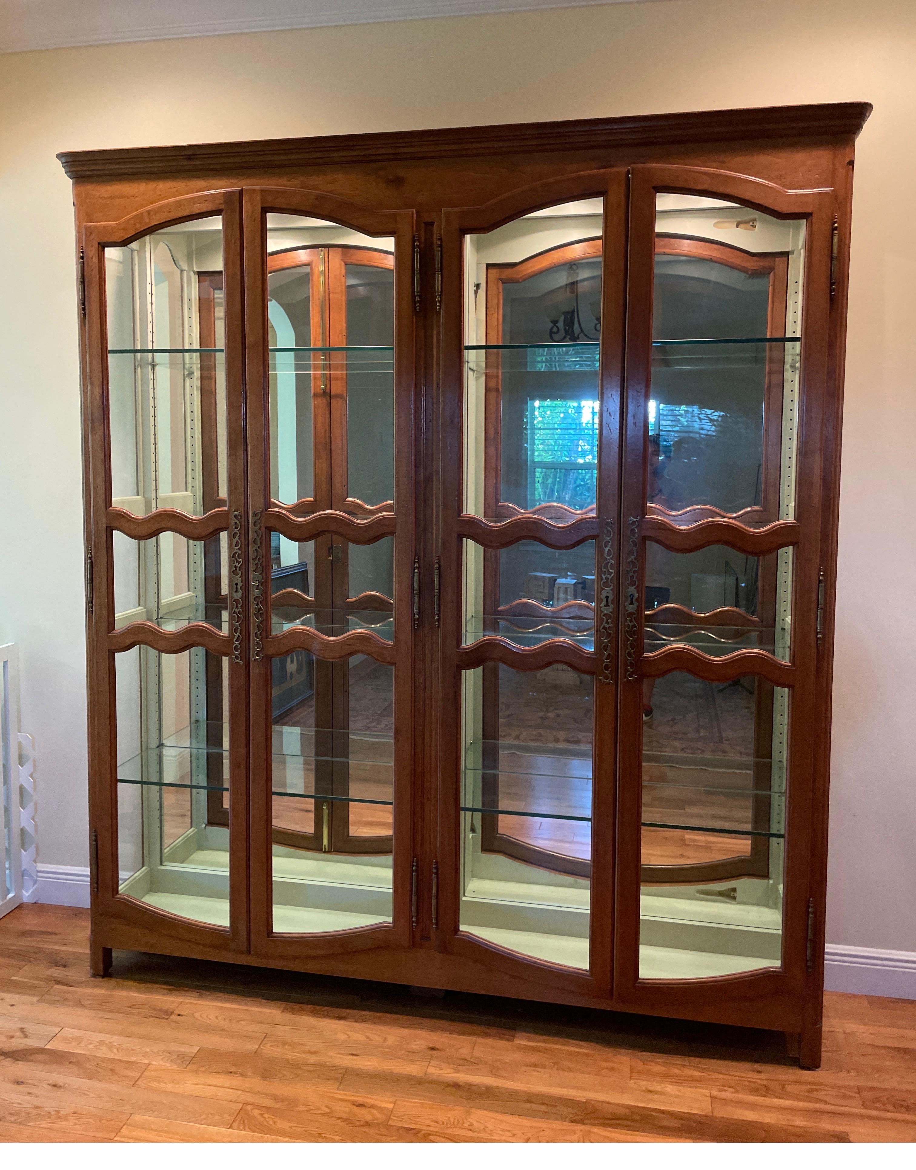 Antique French Bibliotheque / display cabinet. This cabinet comes with adjustable glass shelves and a later mirrored back wall. The four front doors and side panels are fitted with glass.