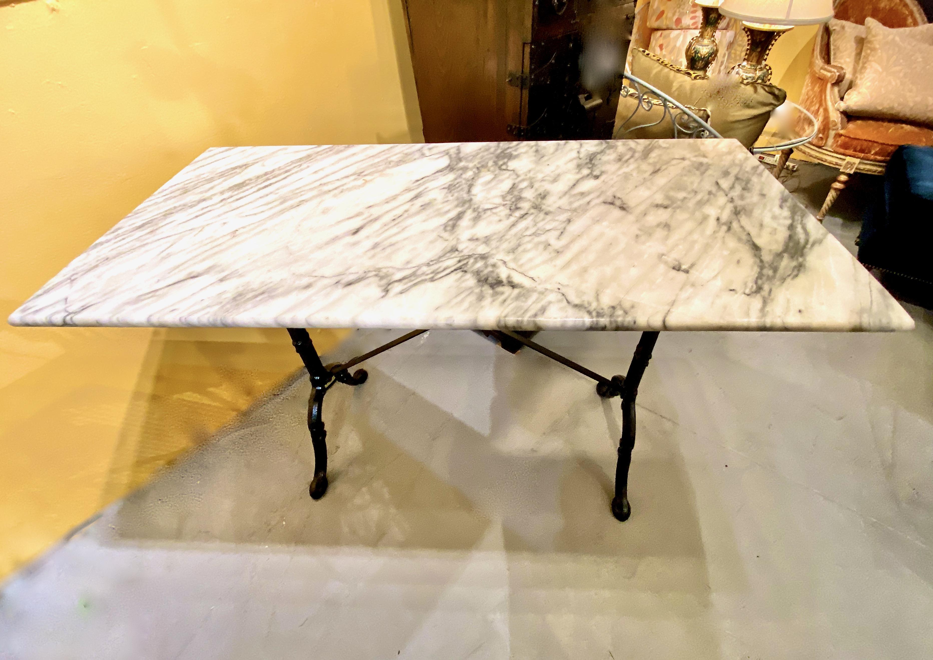 This is a superb example of an early 20th century antique French marble-top Bistro Table. The table is in overall very good condition and features a cast iron base and fine grey and white marble top. The generous size of the table allows it to adapt