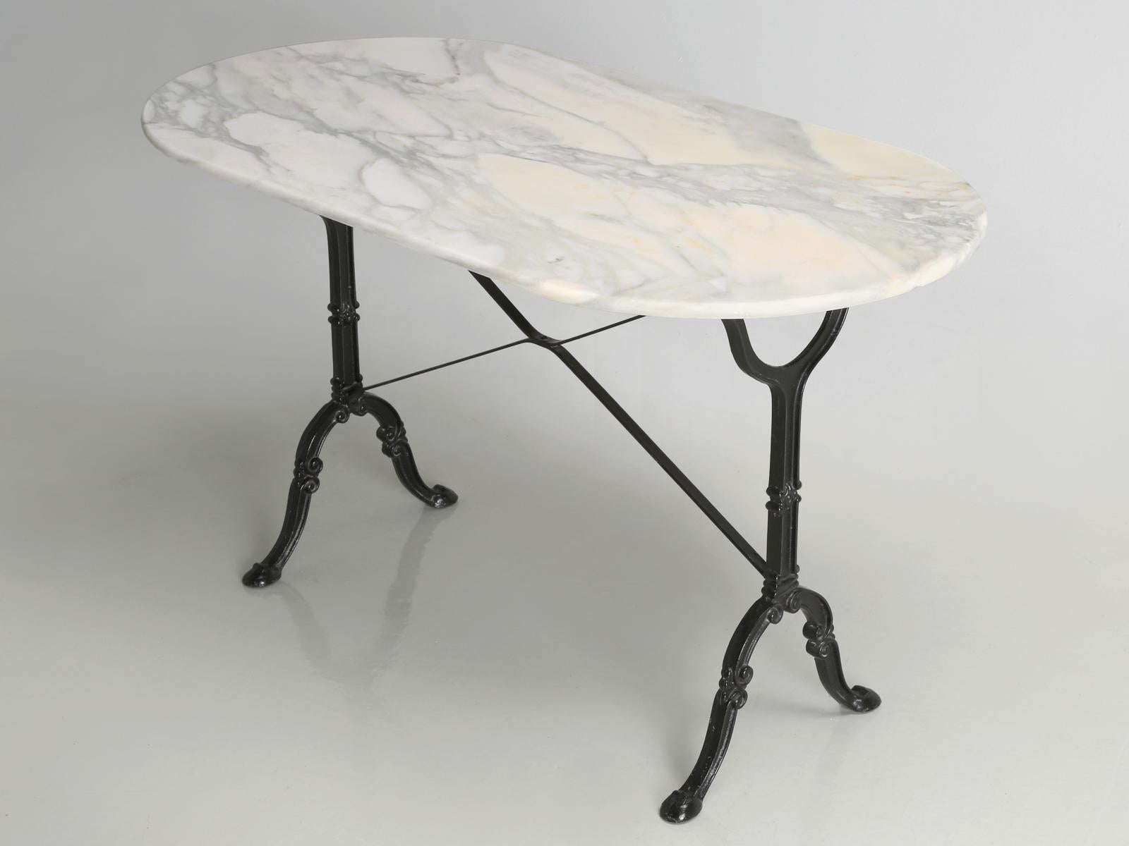 Antique French Bistro table with an exceptionally beautiful honed marble top, which I have to say is a rarity. There are the common chips as one would come to expect in an old commercial table and the small rust stains that are all so common in old