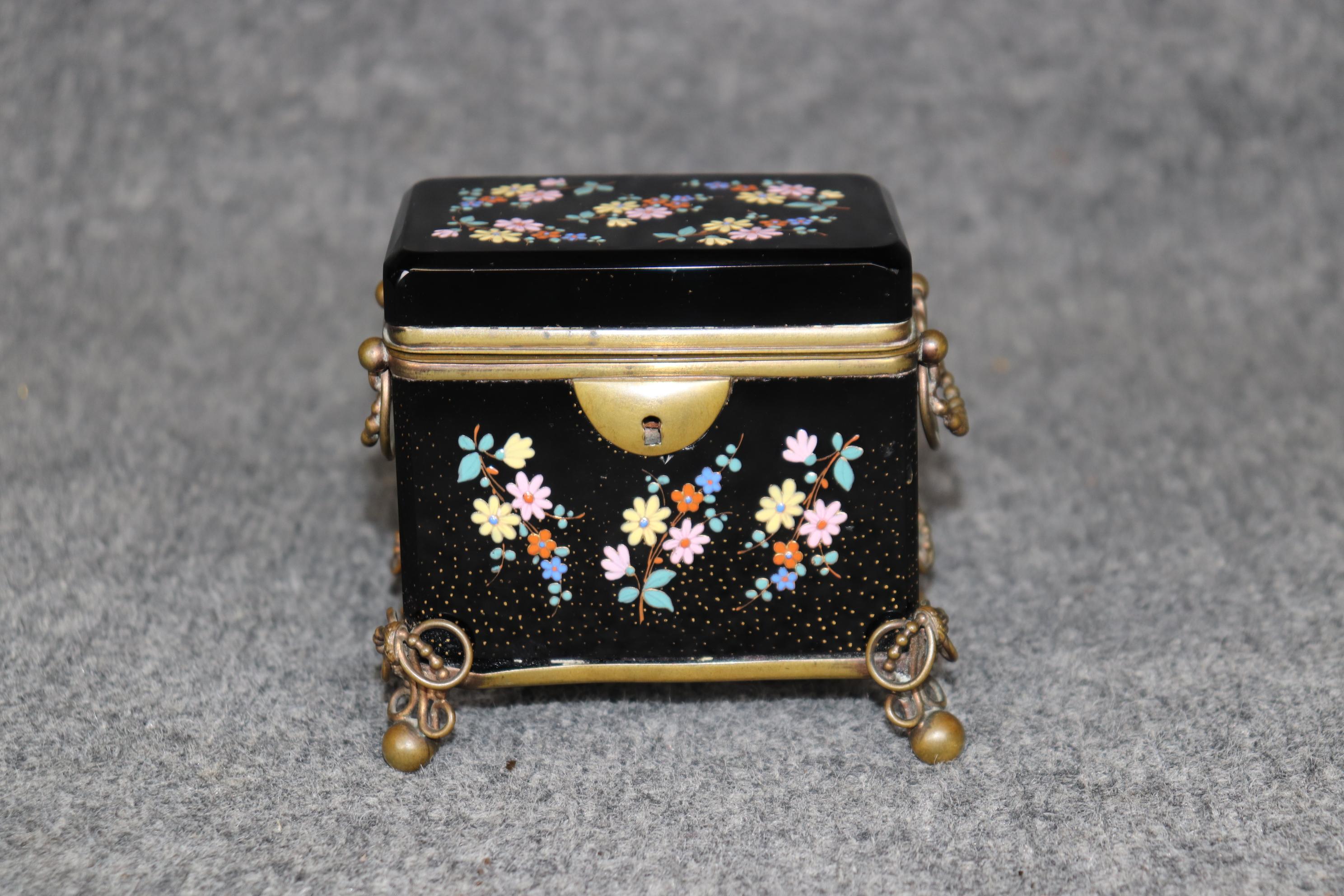 Dimensions - H: 4 1/4 in W: 4 1/2 in D: 3 in

This Antique French 19th Century Black Cut Crystal and Bronze Jewelry Box showcases the remarkable craftsmanship and elegance of the era. The box features a stunning black cut crystal body that whispers