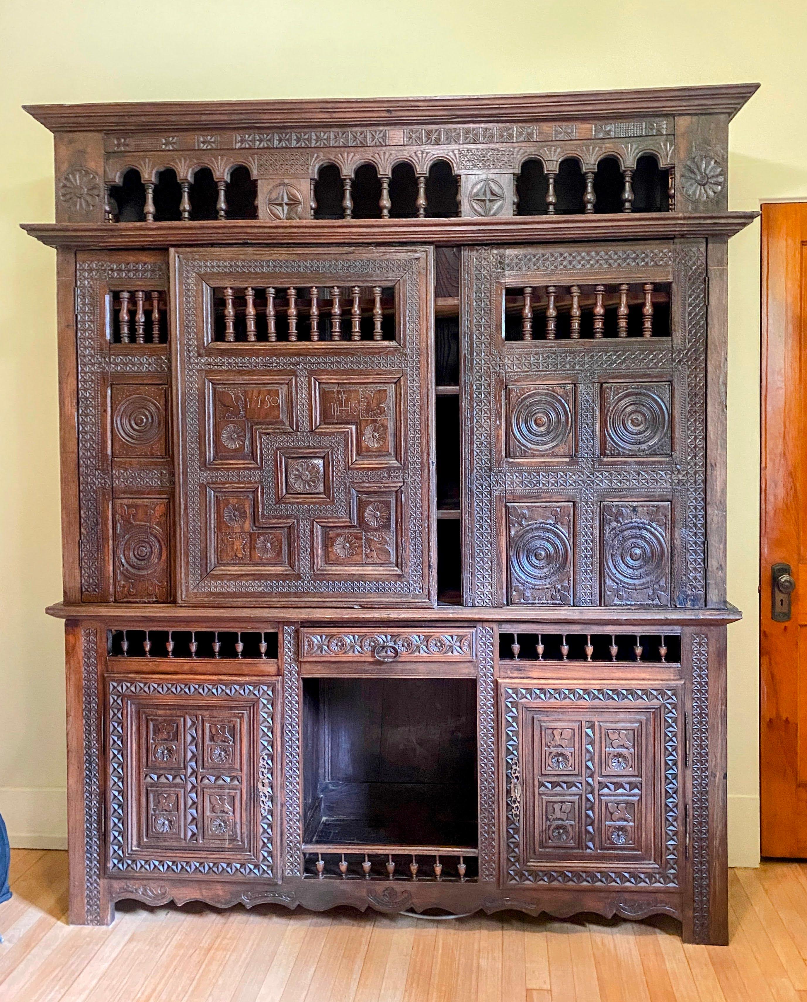 Antique French Black Stained Oak Lit Clos Cabinet, 18th C. This piece makes a stunning bookcase and storage cabinet. This intricately carved and detailed piece originated in Brittany, C 1750. (upper portion). The date 1750 is carved in one panel