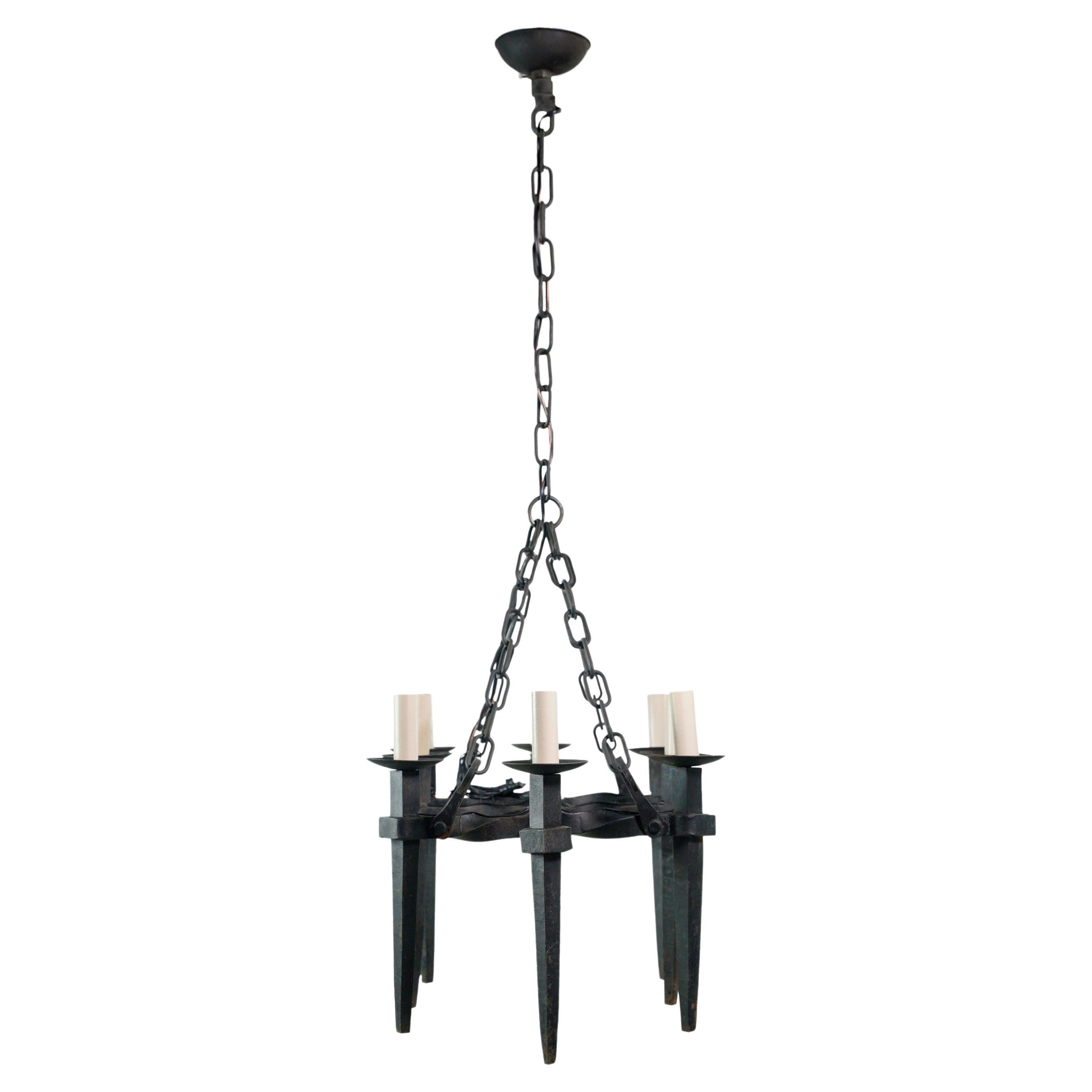 Exquisite antique French chandelier crafted from black wrought iron, featuring eight gracefully curved arms. With its intricate detailing and timeless elegance, this chandelier is a captivating centerpiece that adds a touch of grandeur to any space.